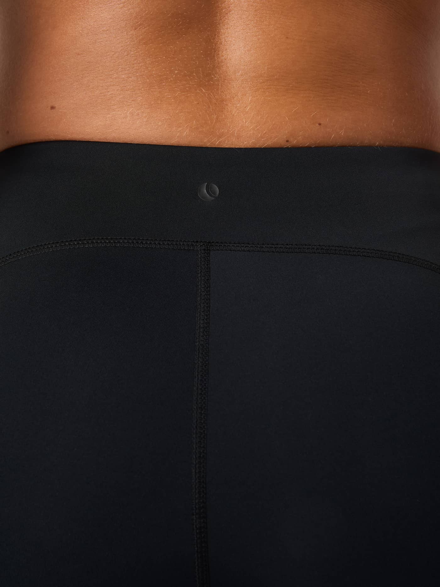 Close-up back view of the Borg Running Short Tights in Black Beauty (Black), highlighting the slim fit and logo detail. - Image 6