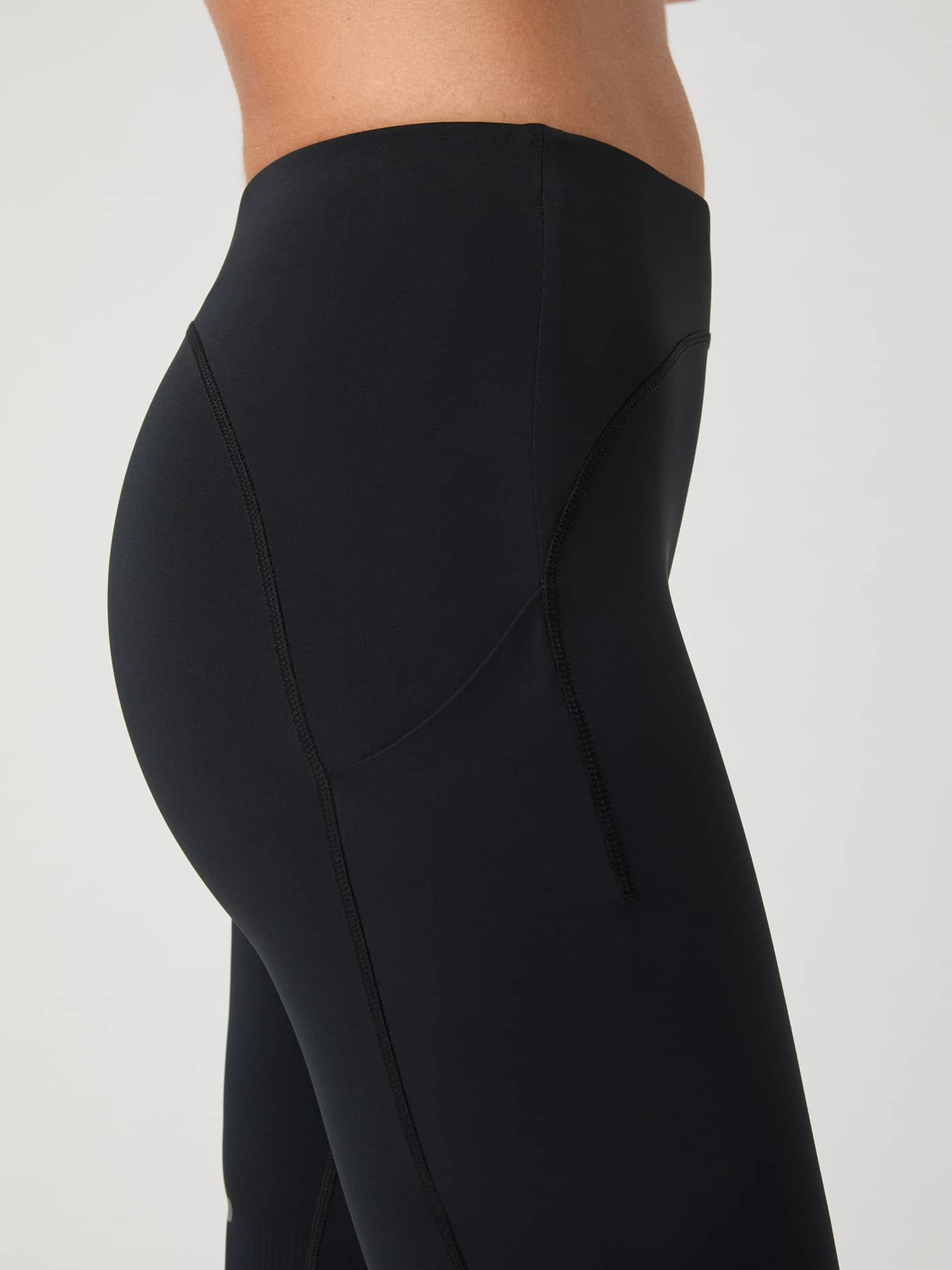 Slim-fit women's Björn Borg Running Short Tights in Black Beauty (Black) shown in a side close-up with a phone pocket. - Image 5