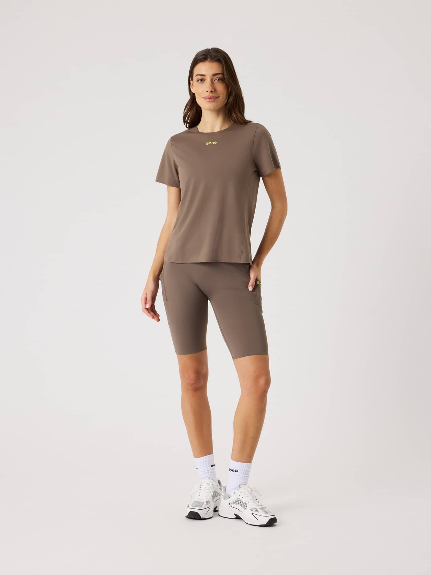 Full-body front view of a model in Falcon (Brown) Borg Performance Short Tights with a lime logo for a running fit. - Image 3