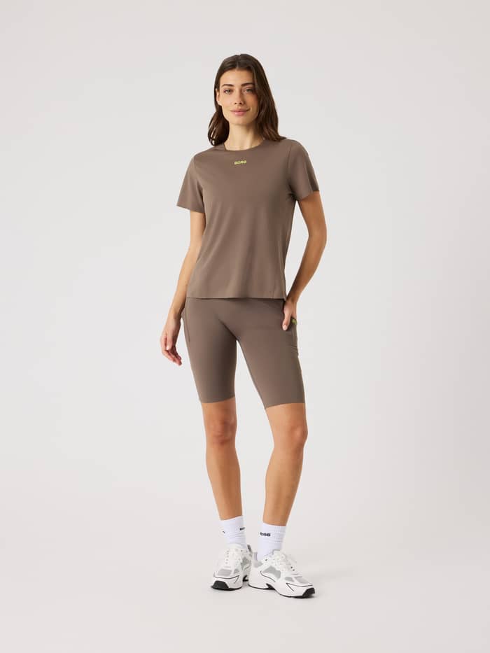 Full-body front view of a model in Falcon (Brown) Borg Performance Short Tights with a lime logo for a running fit. - Image 3