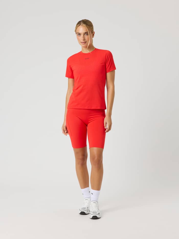 Front view of a model wearing Flame Scarlet (Red) Borg Performance Short Tights, designed for premium running. - Image 3