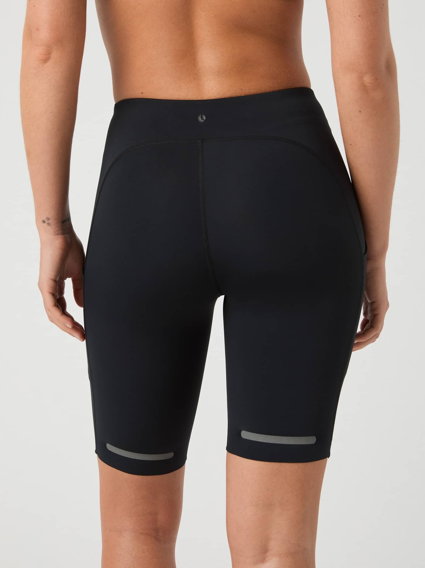 Back view of a model wearing the slim fit Björn Borg Running Short Tights in Black Beauty (Black) with reflective strips. - Image 3