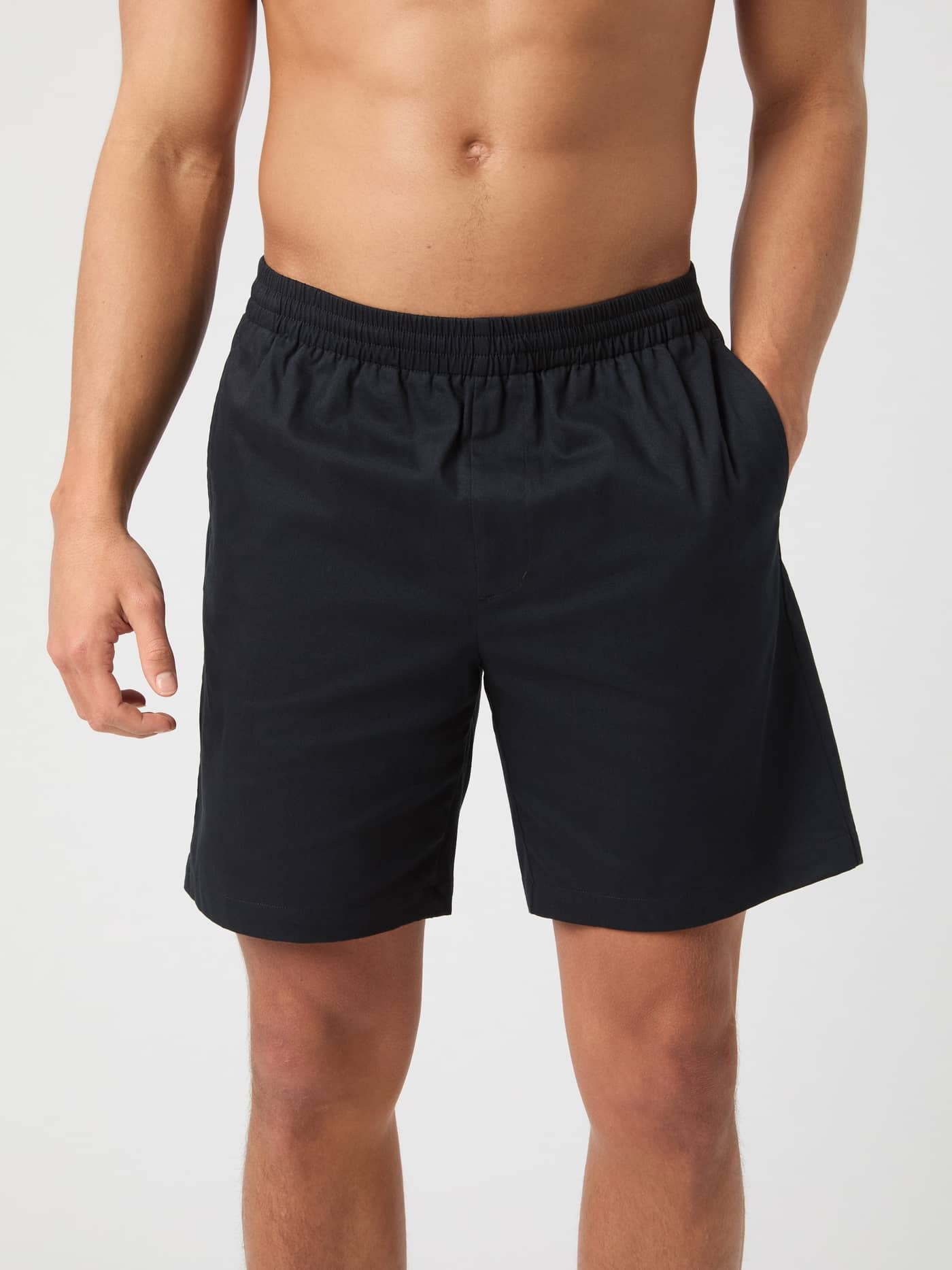 Front view of a man wearing the loose-fit Björn Borg Centre Woven Drawstring Shorts in Black Beauty (Black). - Image 1