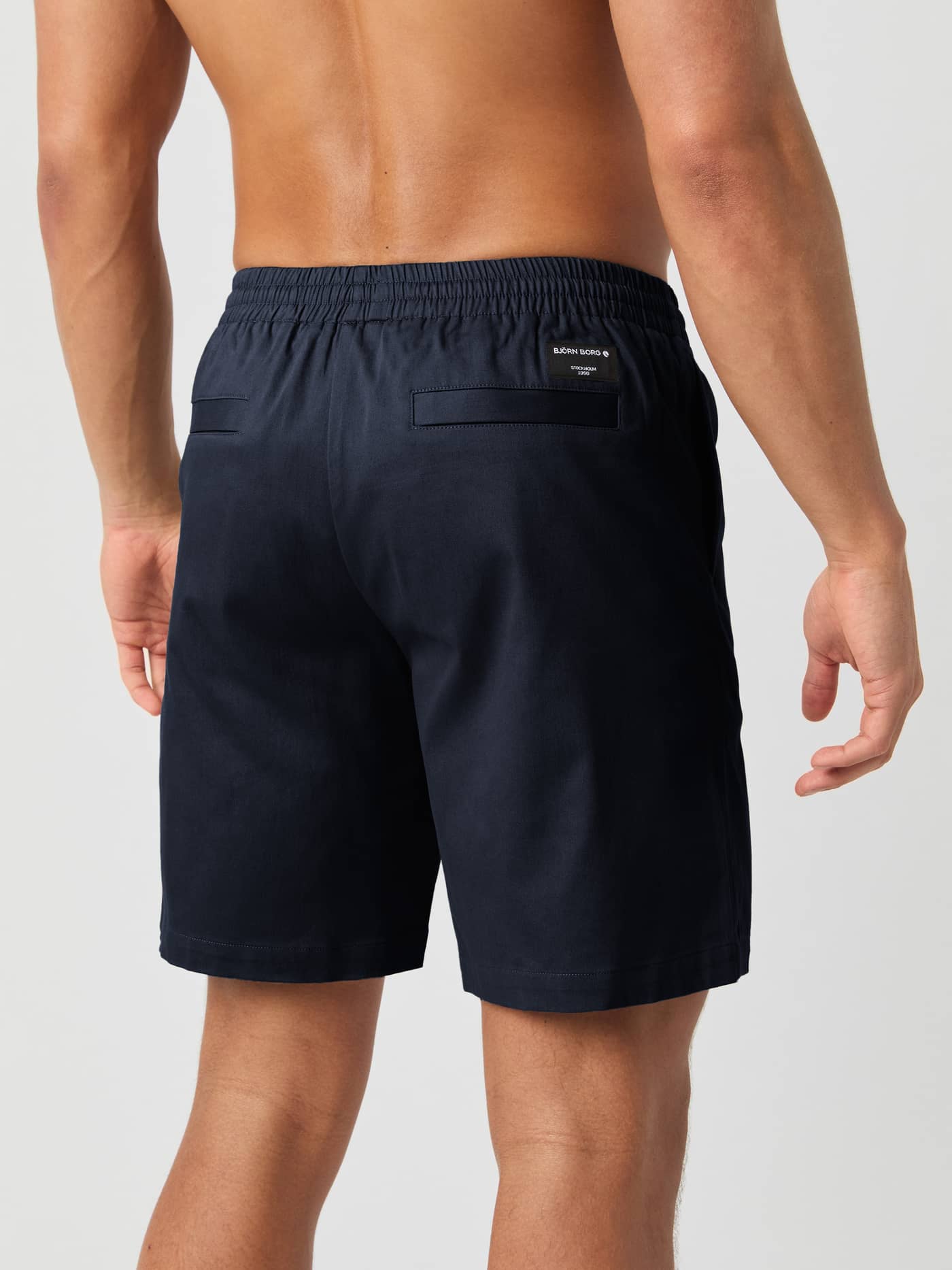 Back view of a man wearing the woven Björn Borg Centre Woven Drawstring Shorts in Night Sky (Navy) with back pockets. - Image 3