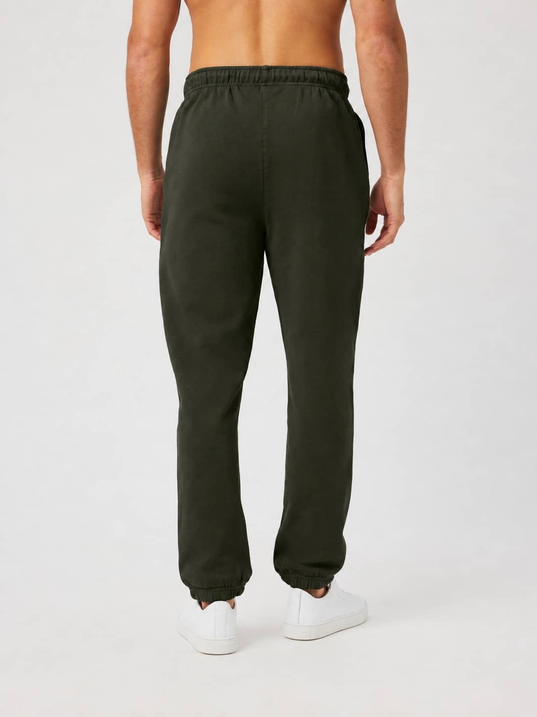 Back view of a model wearing Borg Classic Sweatpants in Rosin (Green) with a solid, regular fit in soft French terry. - Image 2