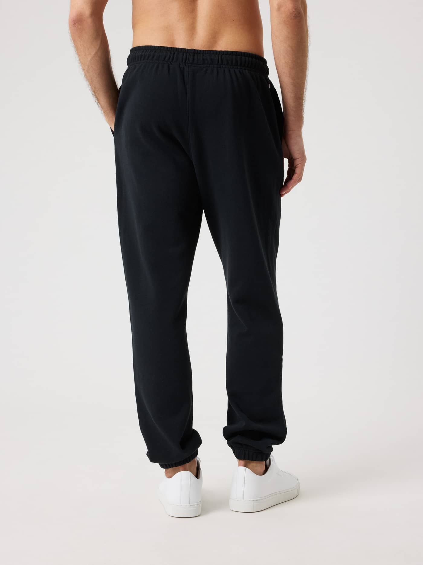 Back view of a man wearing the regular fit Borg Classic Sweatpants in Black Beauty (Black), made from cotton French terry. - Image 3