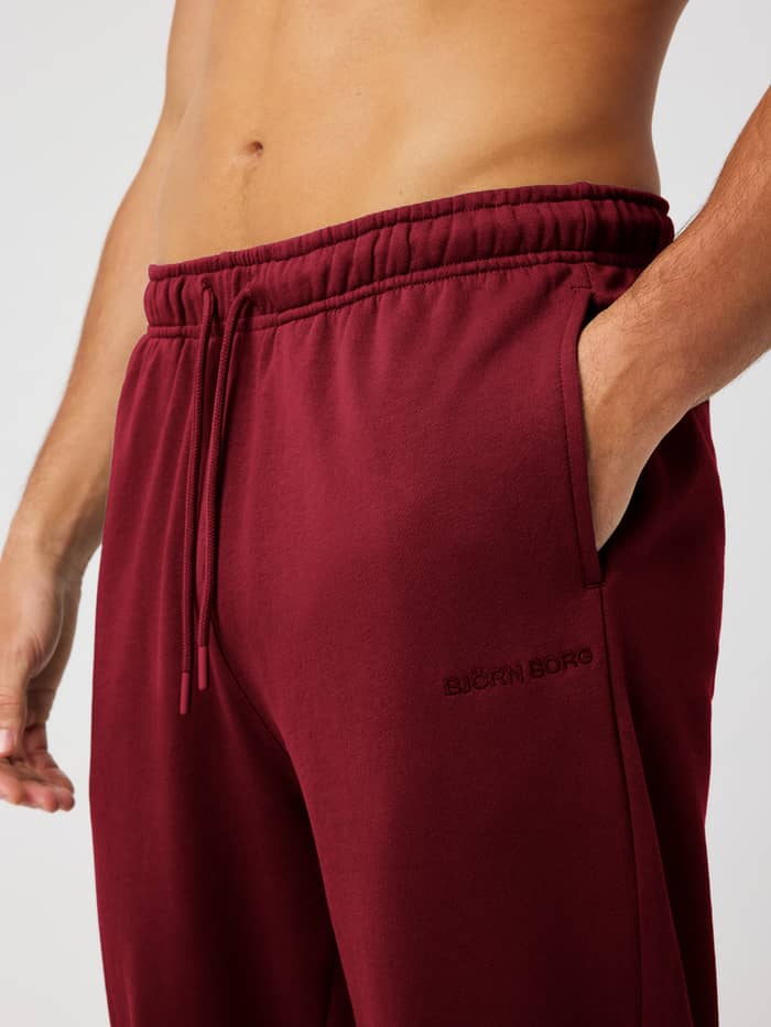 Close-up of the Borg Classic Sweatpants in Cabernet (Red) highlighting the elastic drawstring waist and side pocket.