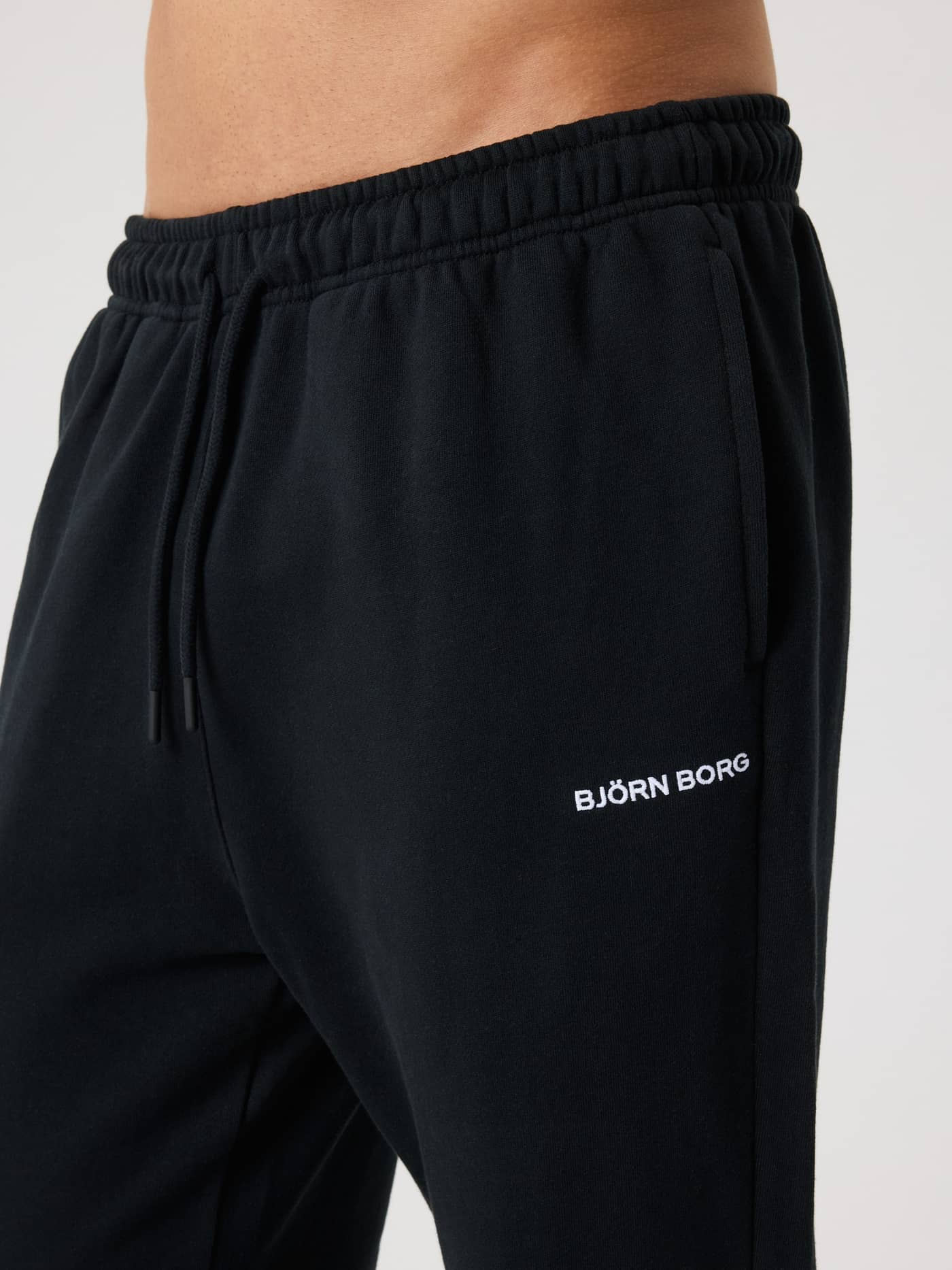 Close-up side view of the men's cotton Borg Classic Sweatpants in Black Beauty (Black) with a white logo. - Image 4