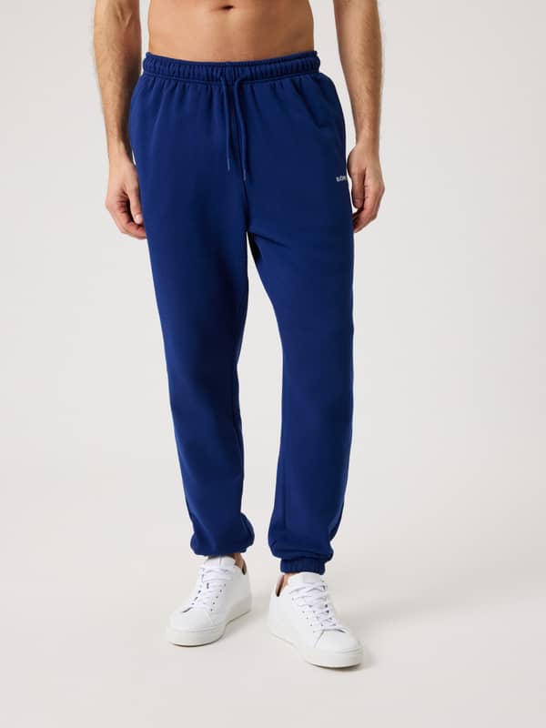 Front view of a man wearing the regular fit Björn Borg Classic Sweatpants in Blue Depths (Blue) made from 100% cotton.