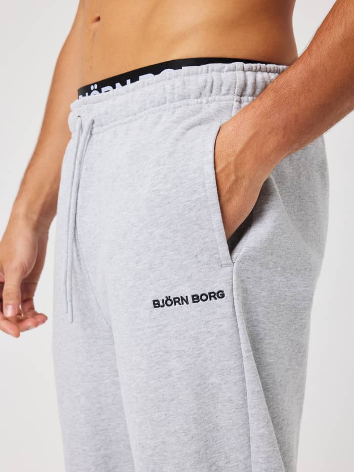 Close-up of the Borg Classic Sweatpants in Ultra Light Grey Melange (grey) showing the pocket, drawstring and black logo.