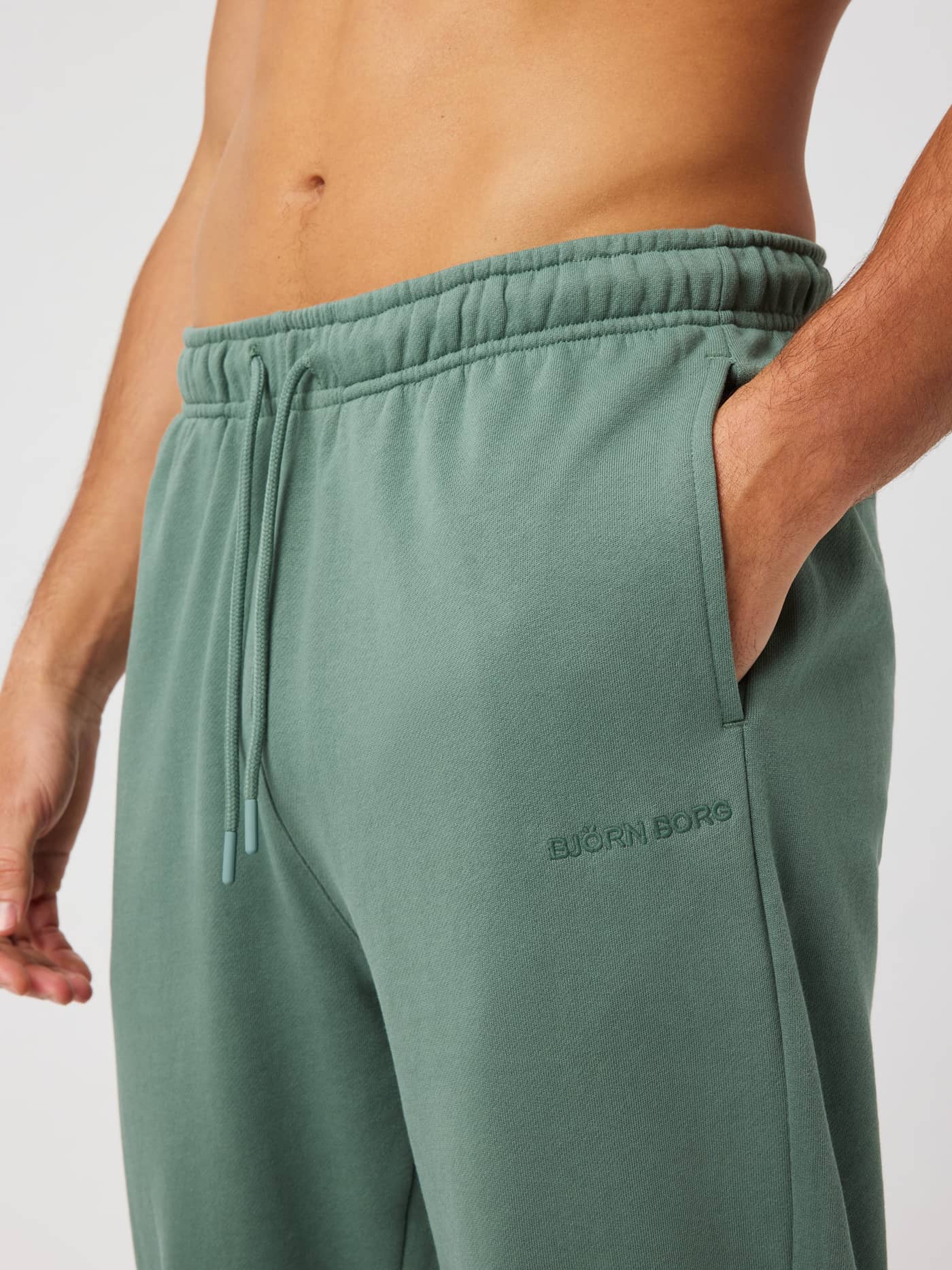 Close-up of the BORG CLASSIC SWEATPANTS in Laurel Wreath (green) highlighting the elastic waistband and side pocket. - Image 4