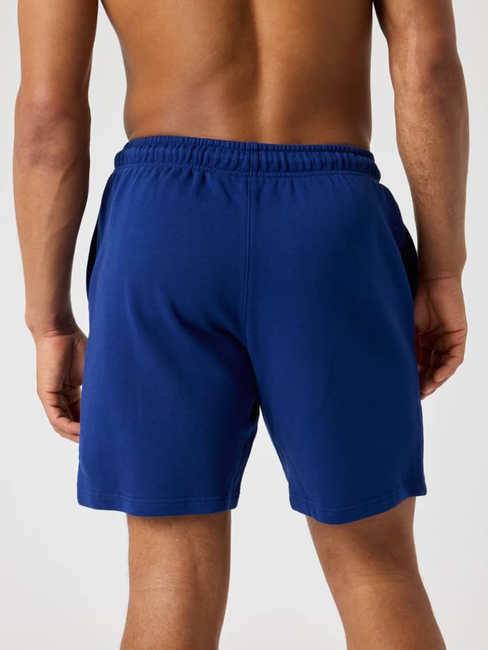 Back view of a man wearing the Borg Classic Sweatshorts in Blue Depths (Blue), made from soft cotton French terry.