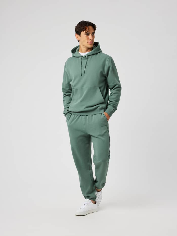 Front view of the Borg Classic Hoodie in Laurel Wreath (Green) featuring an adjustable hood and kangaroo pocket.