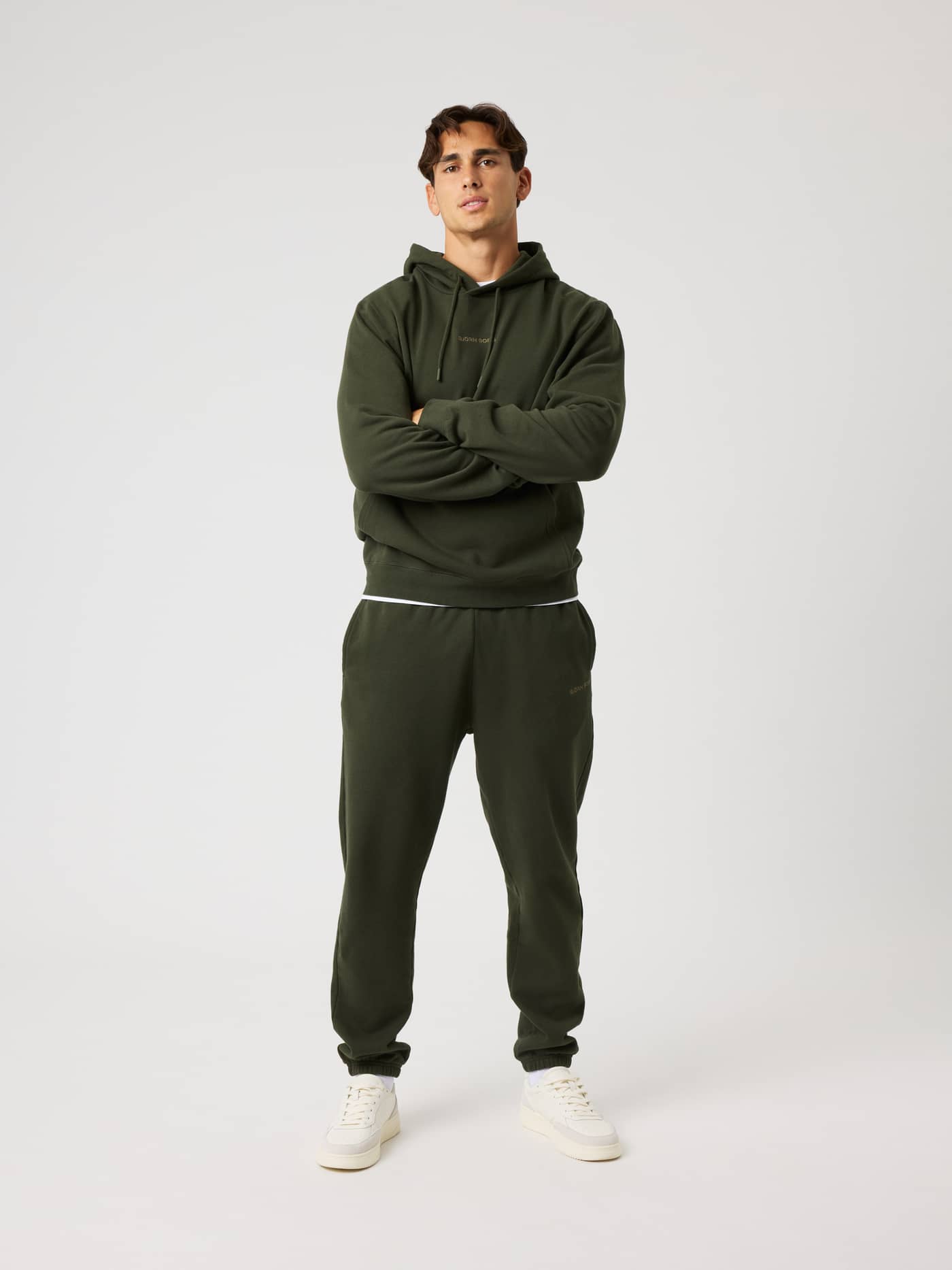 Full-body front view of a model wearing the Borg Classic Hoodie in Rosin (Green), a soft cotton training layer for recovery. - Image 3