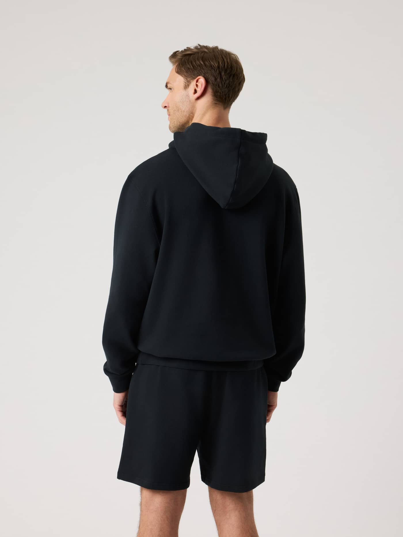 Back view of a man wearing the Borg Classic Hoodie in Black Beauty (Black), highlighting its stylish and functional fit. - Image 3