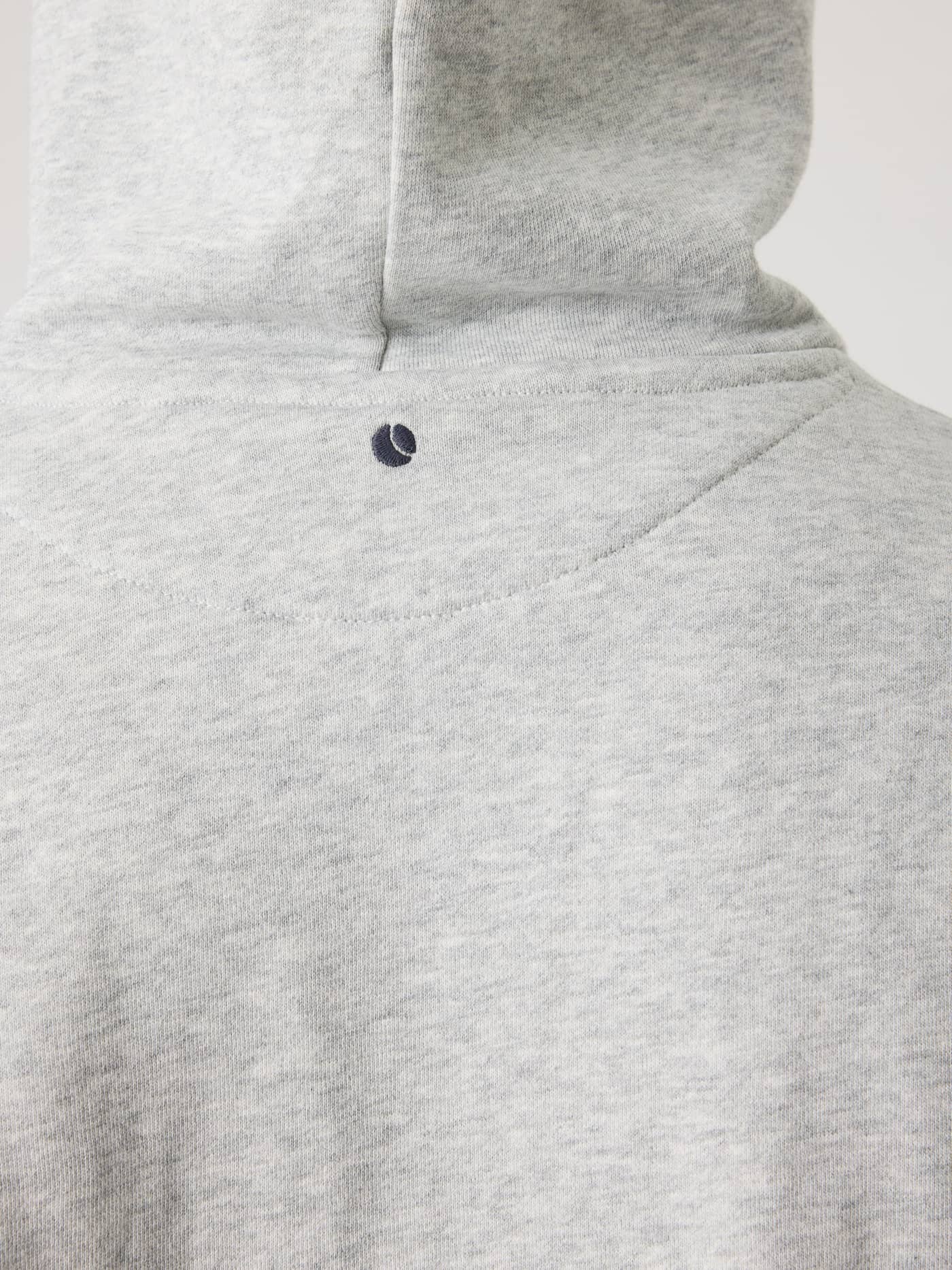 Back view close-up of the Borg Classic Hoodie in Ultra Light Grey Melange (Grey) featuring a tennis ball embroidery. - Image 4