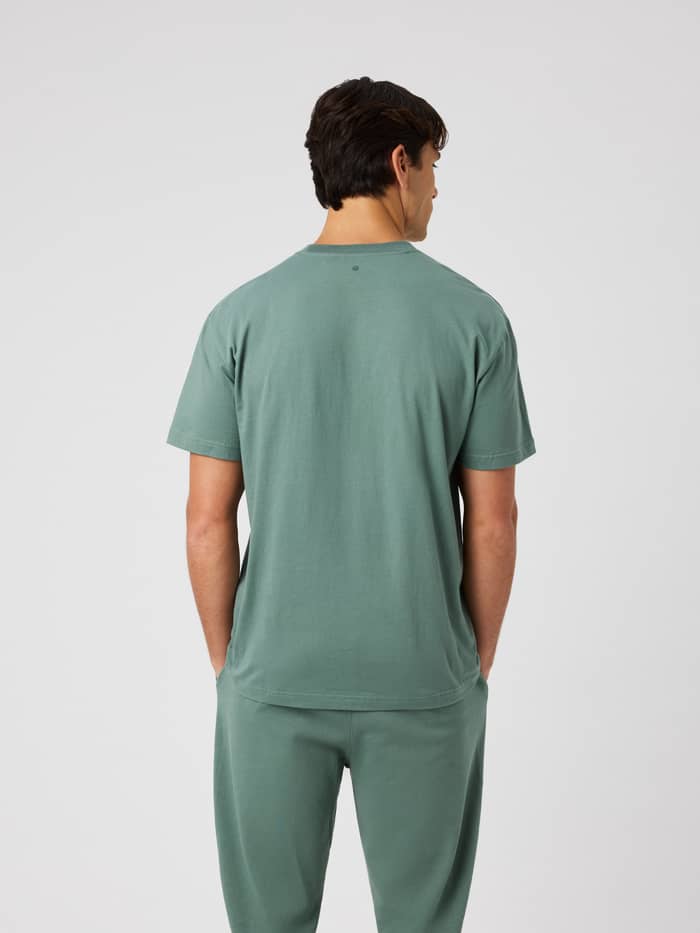 Back view of a man wearing the Borg Classic T-Shirt in Laurel Wreath (Green) highlighting the back design.