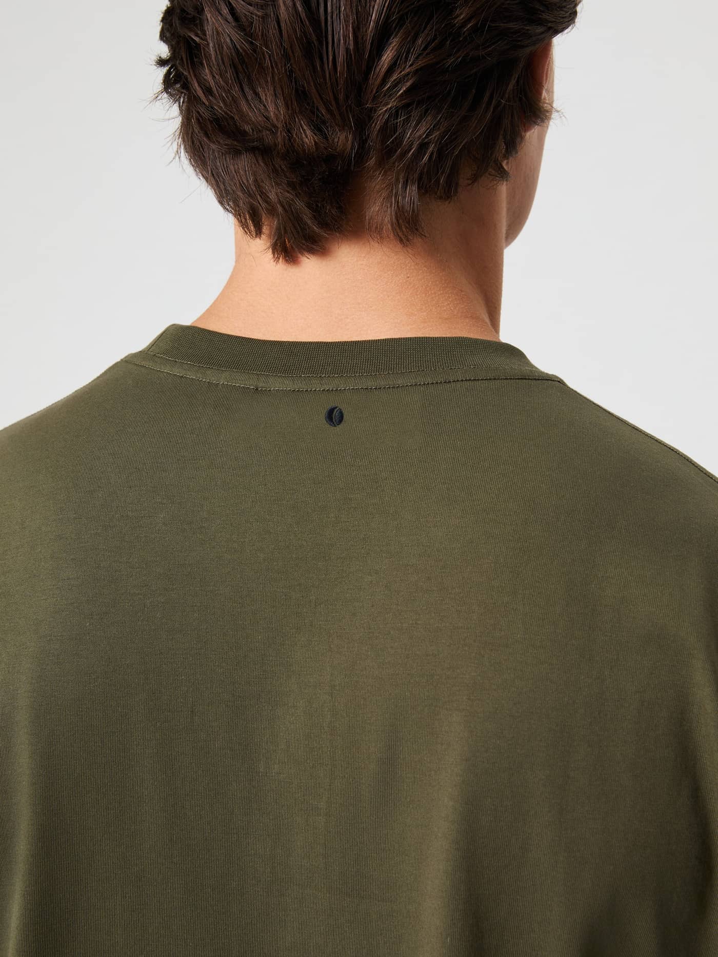 Close-up back view of the Björn Borg Classic T-Shirt in Forest Night (Green) featuring a small tennis logo. - Image 4