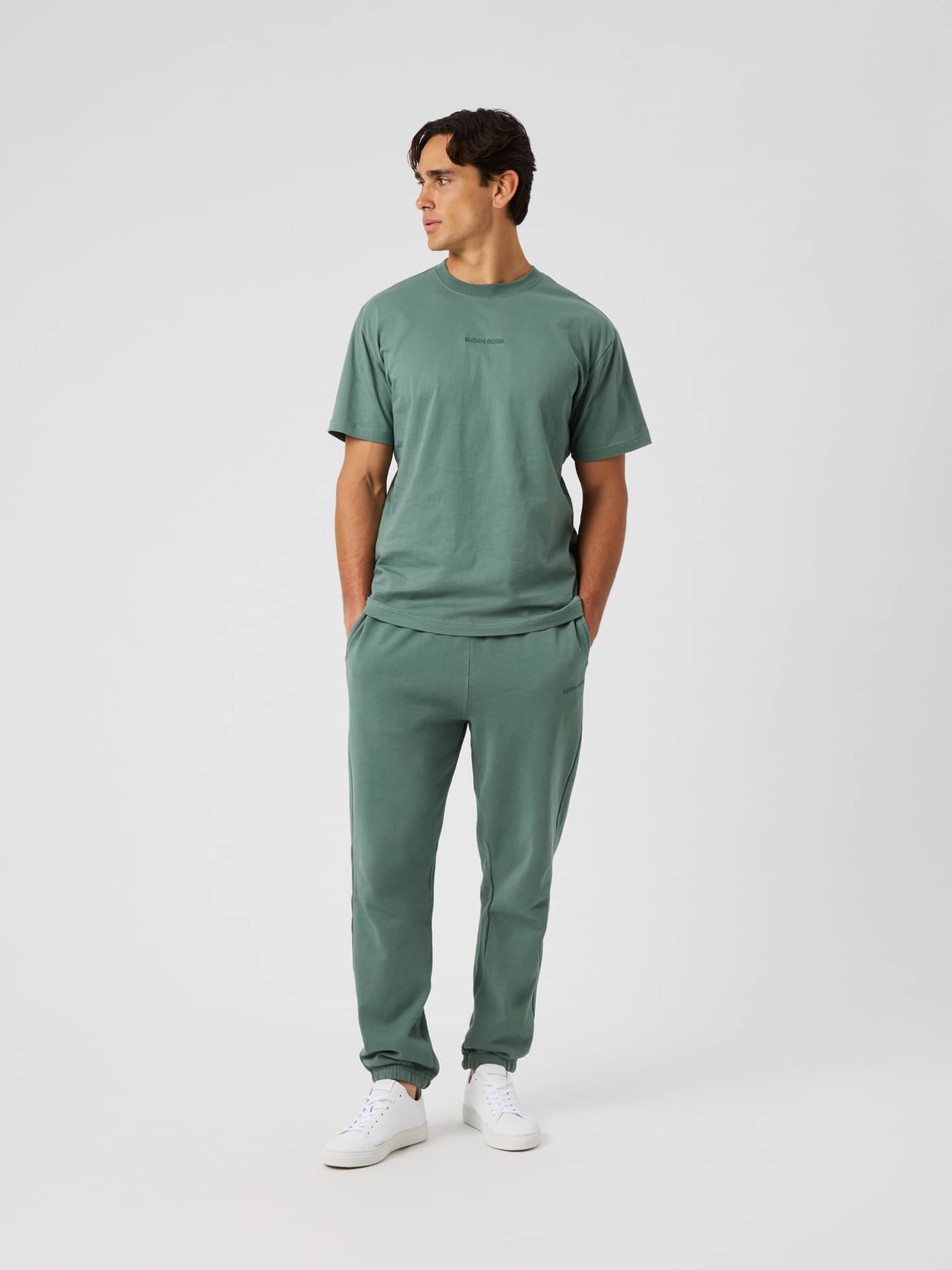 Borg Classic T-Shirt in Laurel Wreath (Green) worn by a model in a studio full-length shot. - Image 4