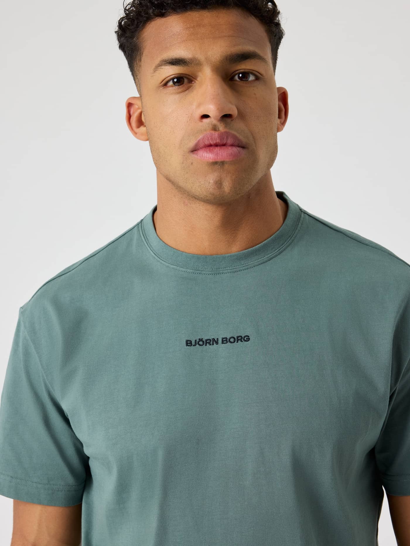 Borg Classic T-Shirt i Balsam Green (Grøn) set forfra på en mand i blød bomuld med et sort logo. - Image 4