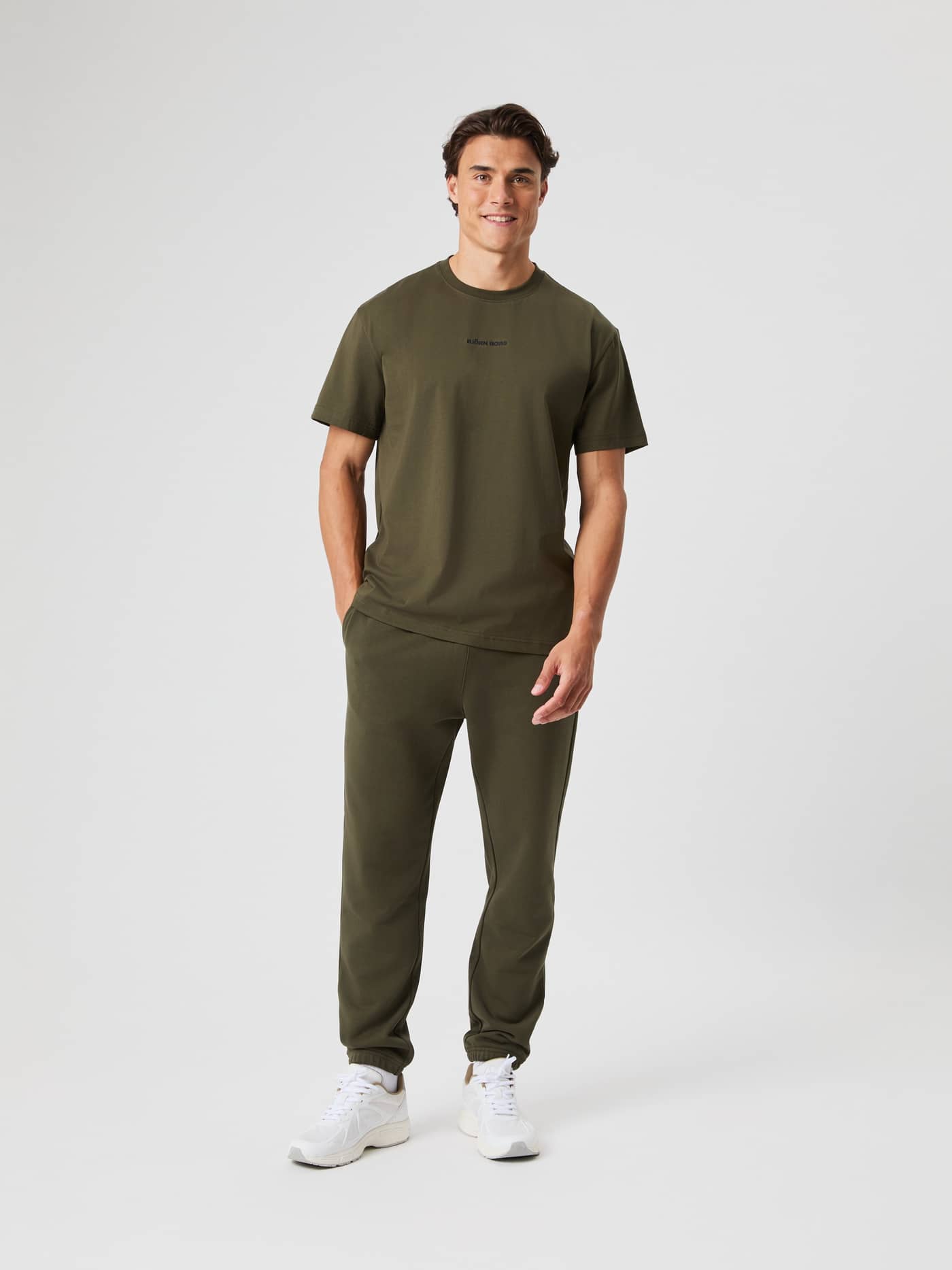 Full-body front view of a man in the soft cotton Björn Borg Classic T-Shirt in Forest Night (Green) with matching sweatpants. - Image 3