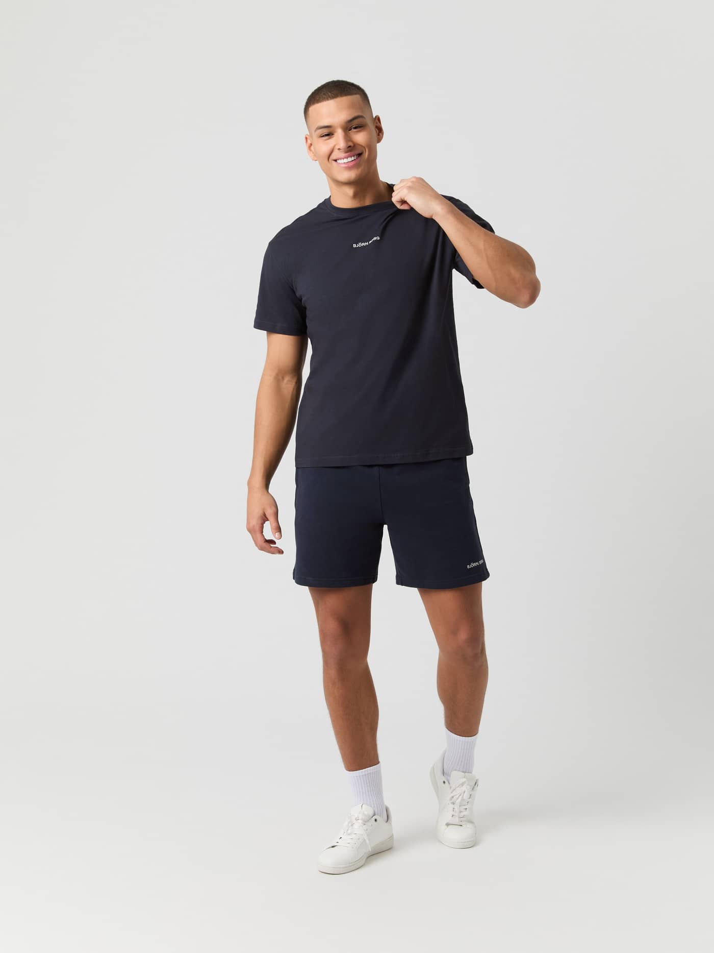 Full-body front view of a man wearing the cotton Borg Classic T-Shirt in Night sky (Navy) with a white logo. - Image 3