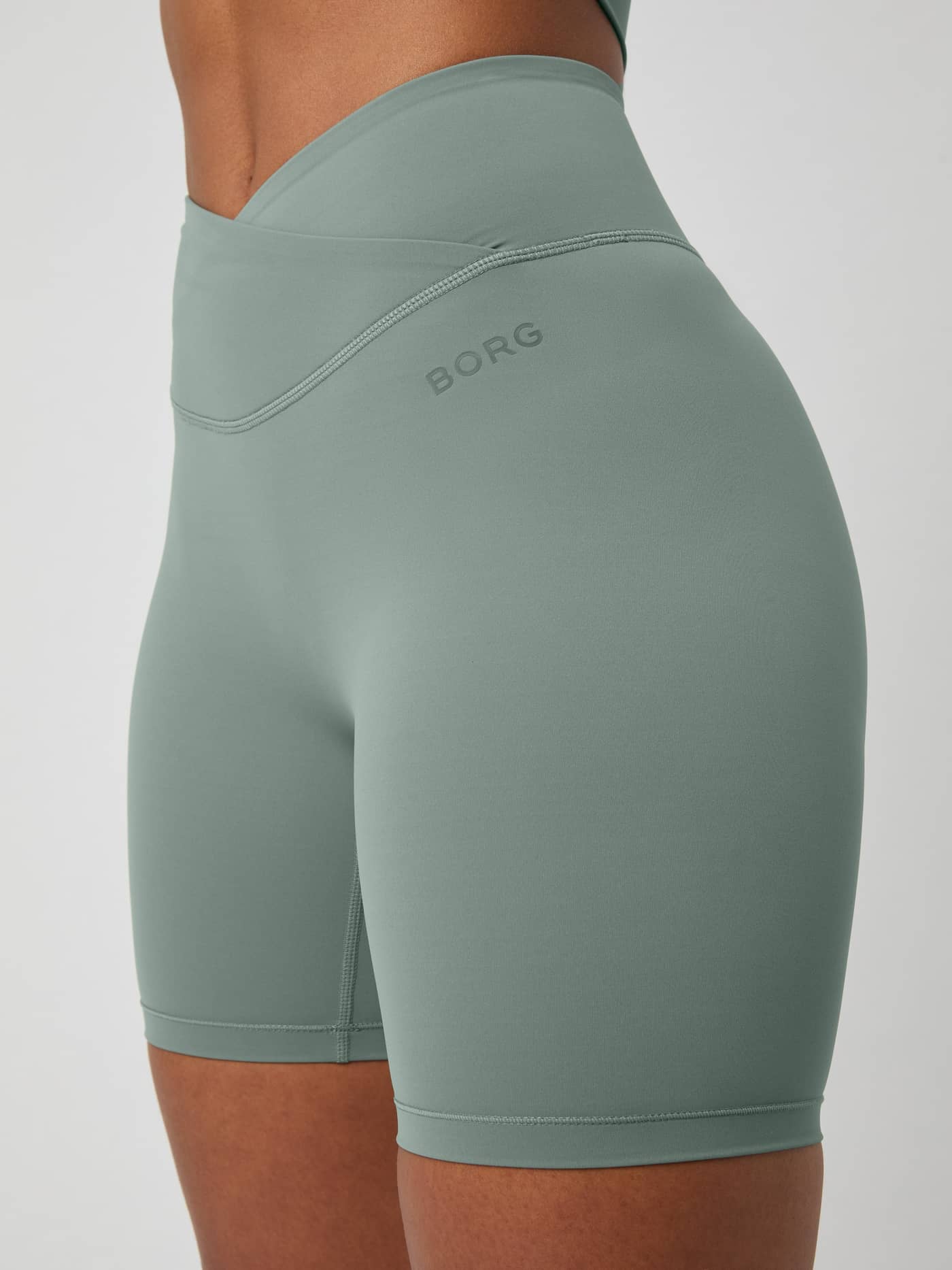 Studio Cross Shorts in Agave Green (Green) for training, showcasing the high-waisted cross overlap and Borg logo. - Image 4