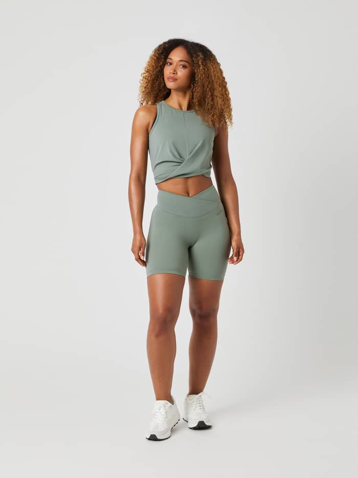Full-body front view of a model in Björn Borg Studio Cross Shorts in Agave Green (Green) for a high waist training fit. - Image 3