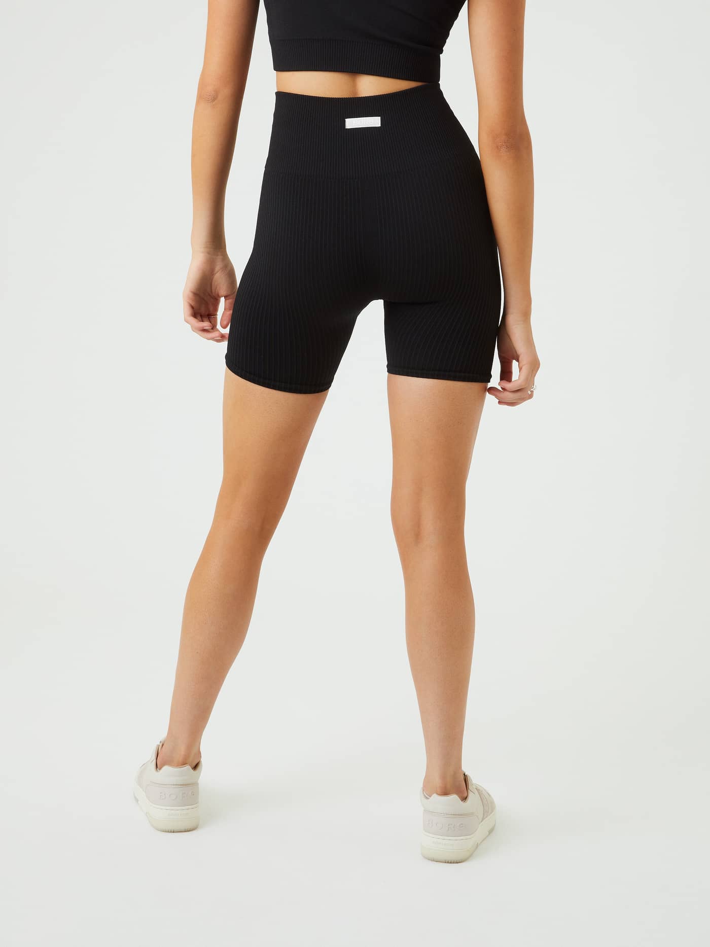 Back view of the Björn Borg Studio Seamless Ribbed Shorts in Black Beauty (Black), featuring a ribbed fit for training. - Image 5