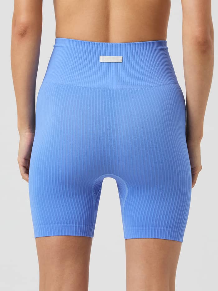 Back view of Björn Borg Studio Seamless Ribbed Shorts in Ultramarine (Blue) for training with a high waist and white logo. - Image 3