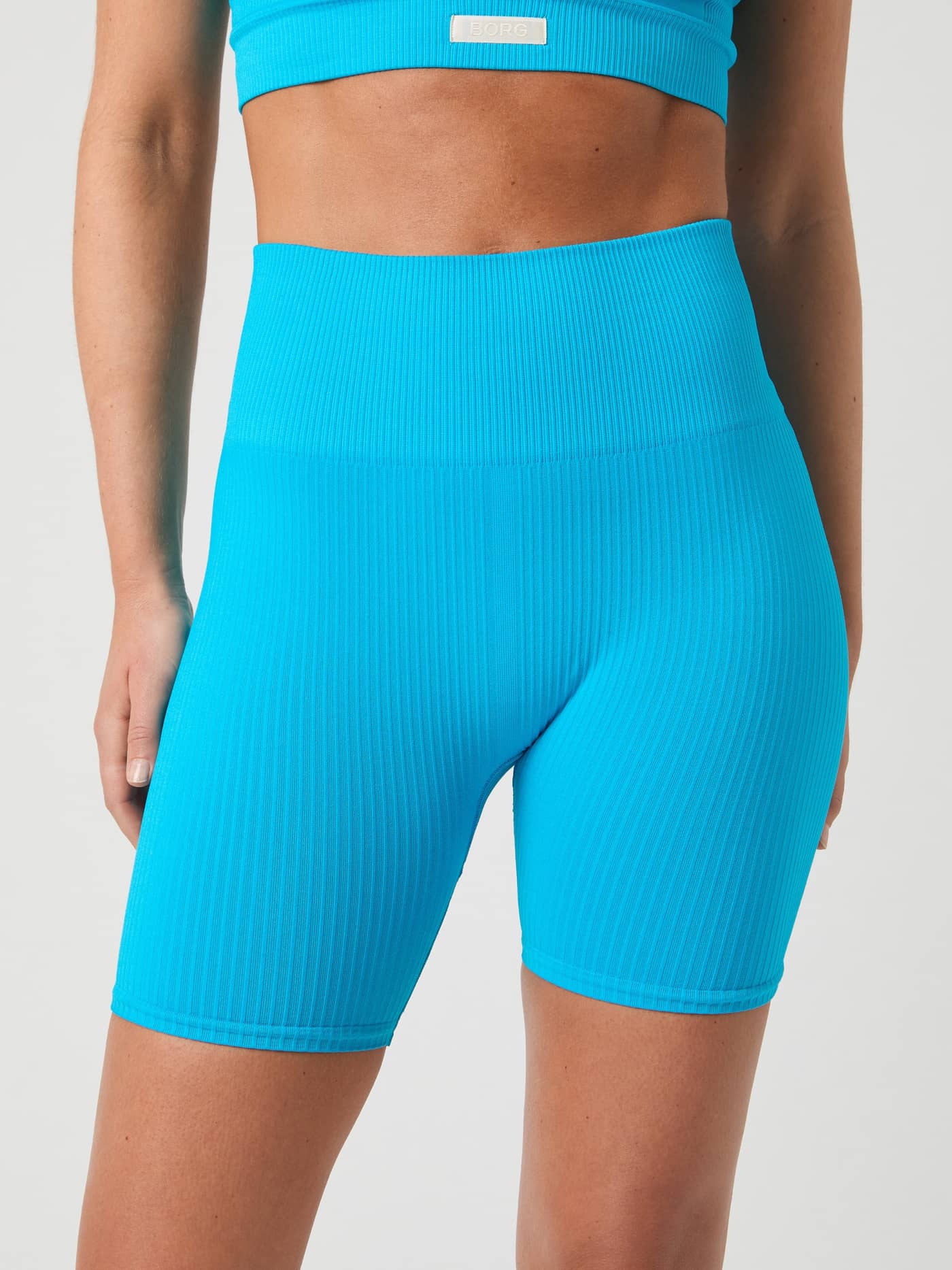 Front view of Atomic Blue (Blue) Studio Seamless Ribbed Shorts, with a high-waisted seamless fit for training. - Image 3