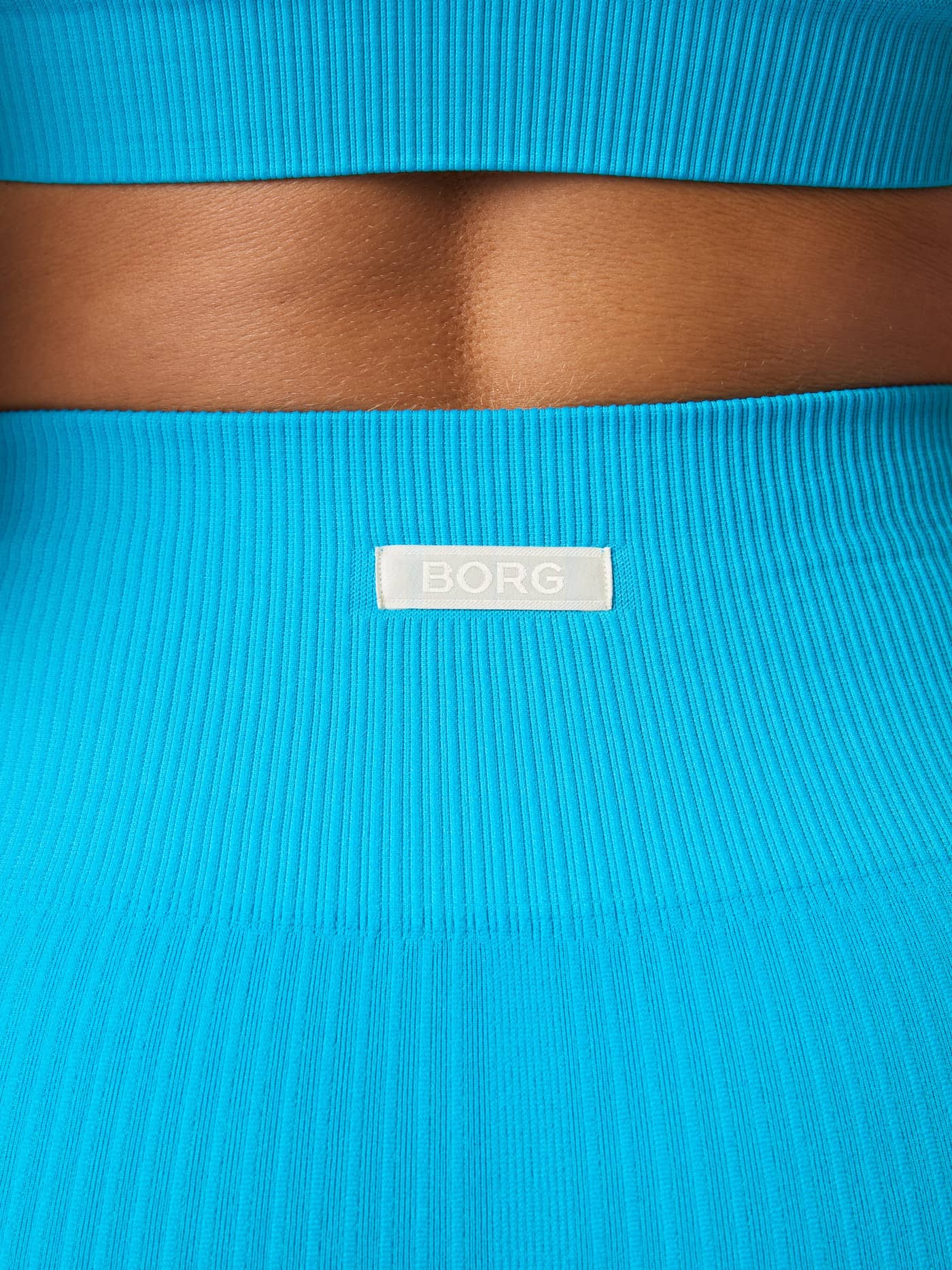 Detailed back view of the Atomic Blue (Blue) Studio Seamless Ribbed Shorts for training, with a white BORG logo label. - Image 7