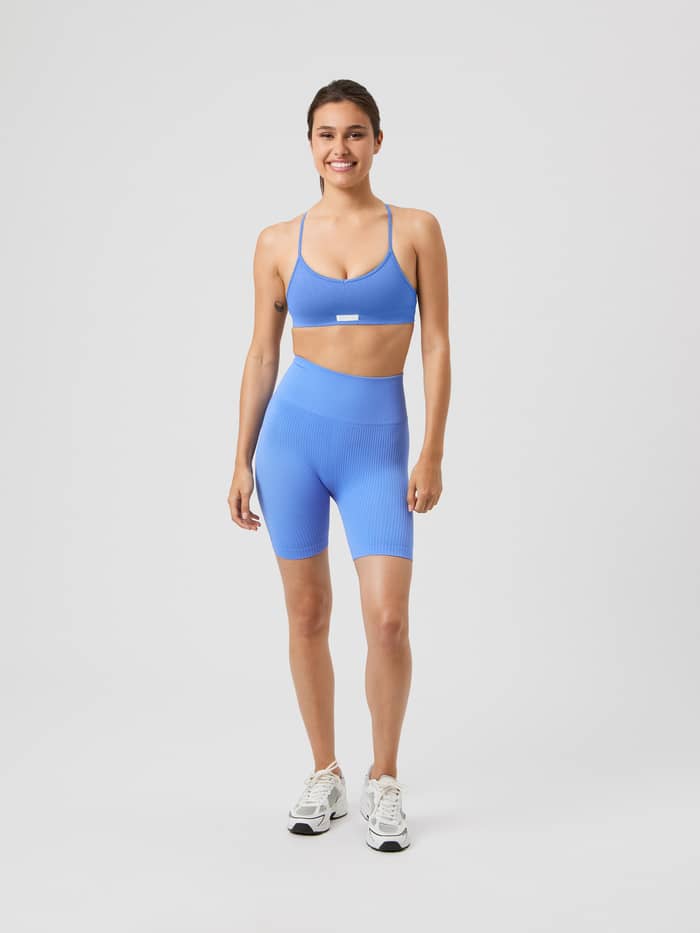 Full-body front view of a model in Ultramarine (Blue) Studio Seamless Ribbed Shorts with a high-waisted training fit. - Image 4