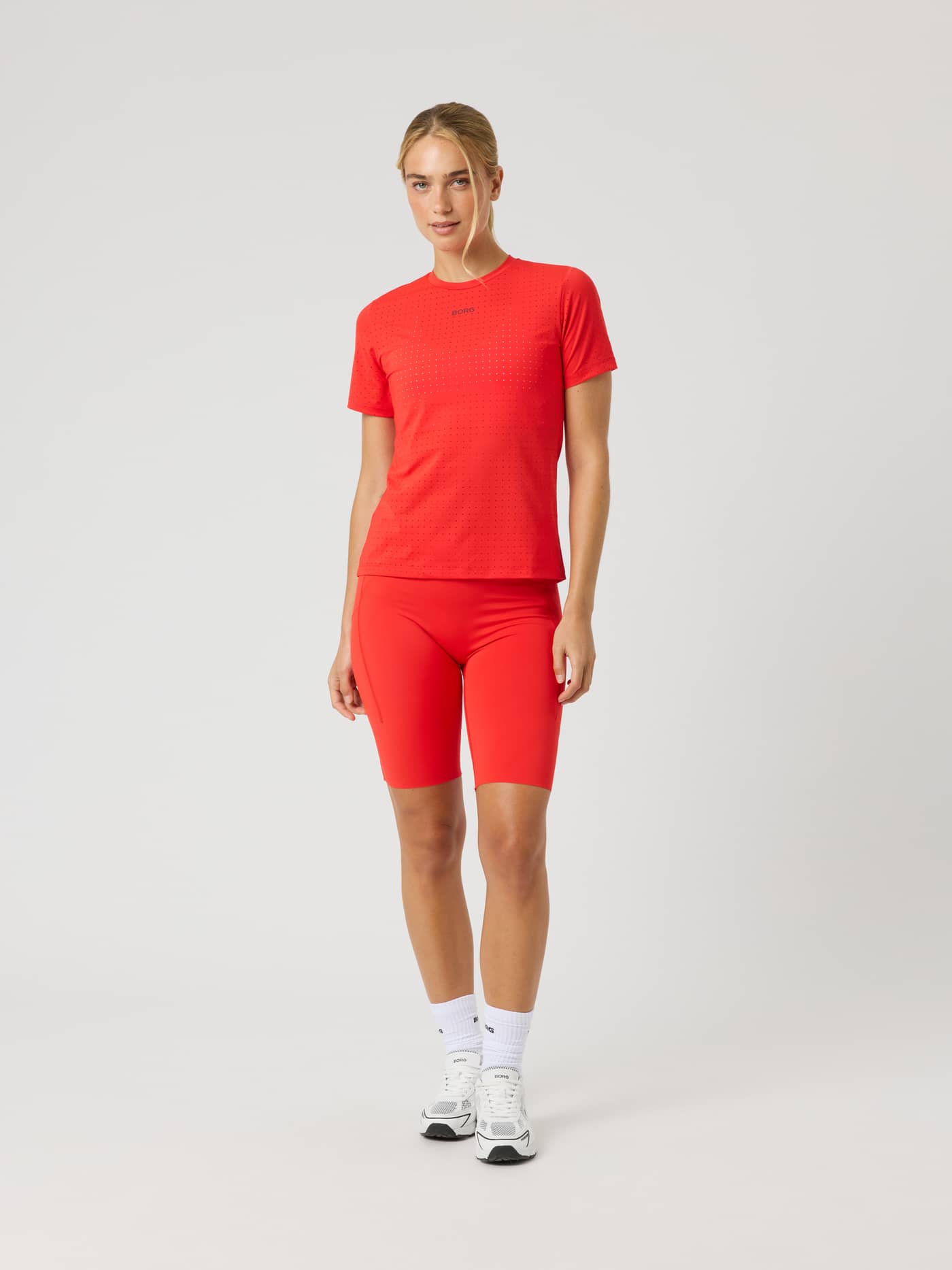 Front view of the Borg Performance Perforated T-Shirt in Flame Scarlet (Red) for running with a small black logo on chest. - Image 3