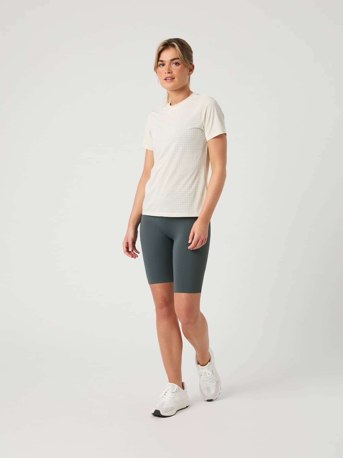 Full-body front view of a model in the stylish regular fit Borg Running Perforated T-Shirt in Birch (White) for running. - Image 4