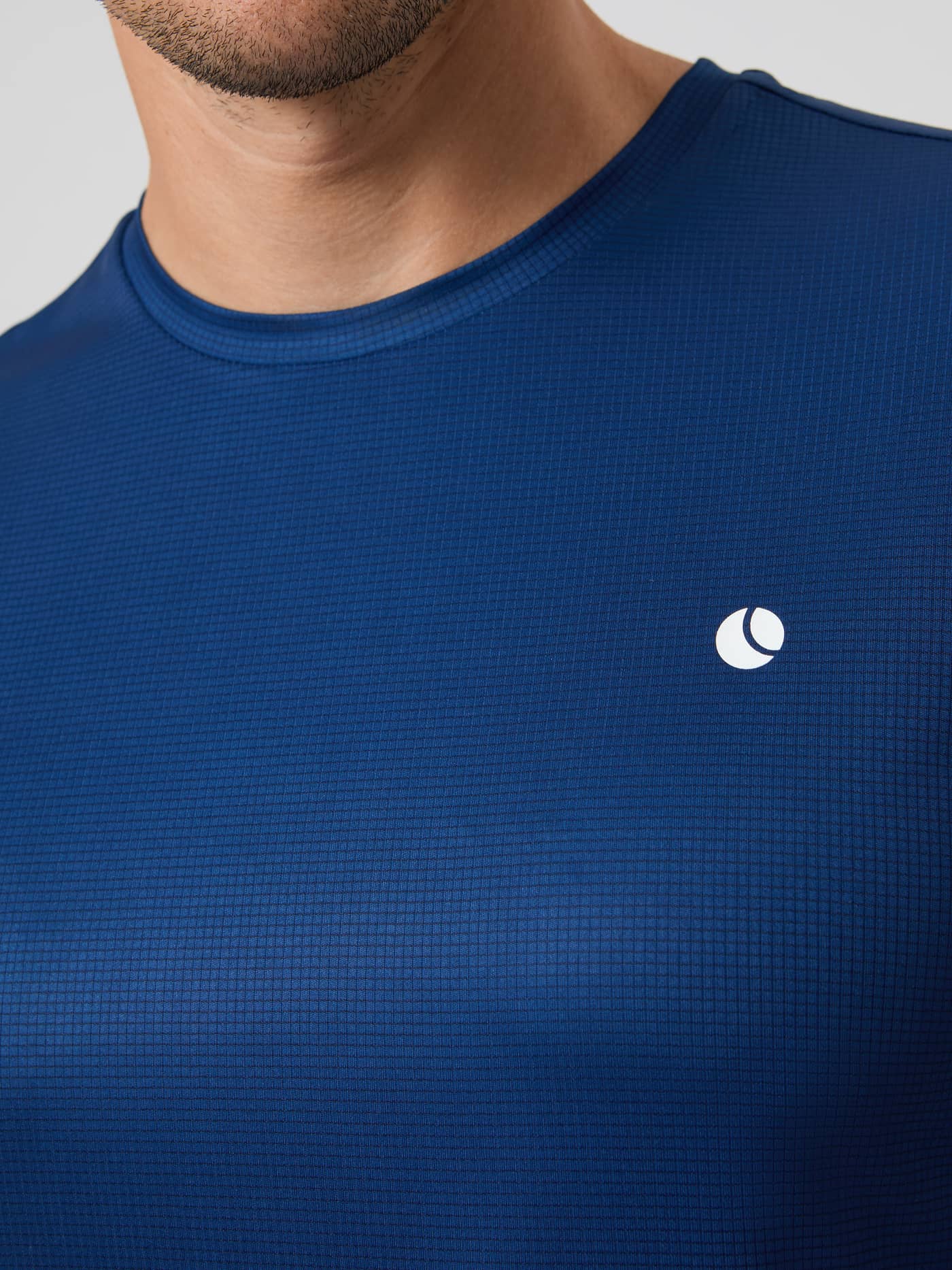 Close-up of the Björn Borg Ace Light T-Shirt in Estate Blue, showing the textured fabric, round neckline, and logo. - Image 5
