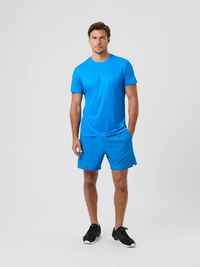 Full-length studio shot of a model wearing the blue Björn Borg Ace Light T-shirt and matching shorts.