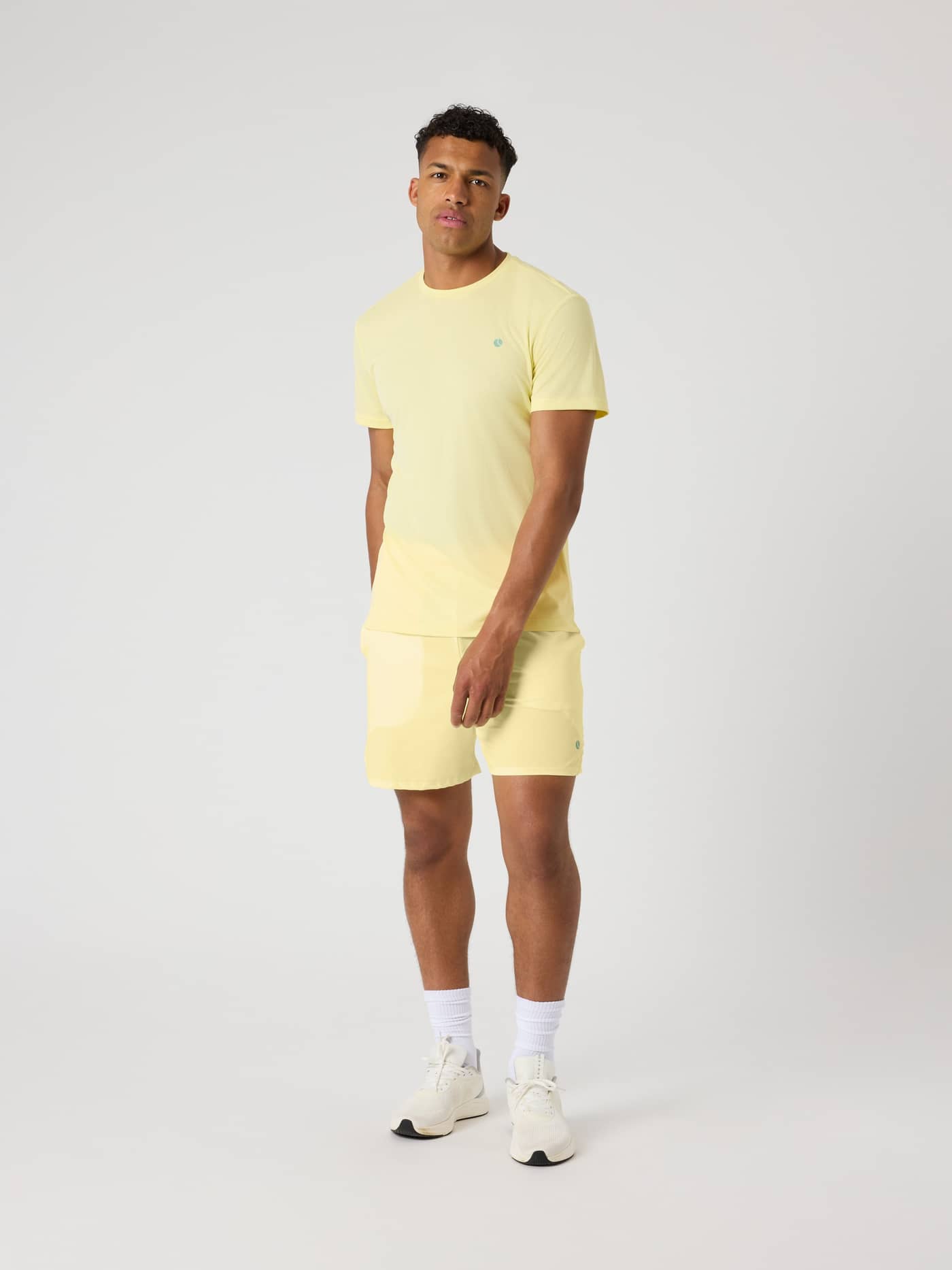 Full-body front view of a man wearing the Björn Borg Ace Light T-Shirt in Lemonade (Yellow) for performance tennis. - Image 3