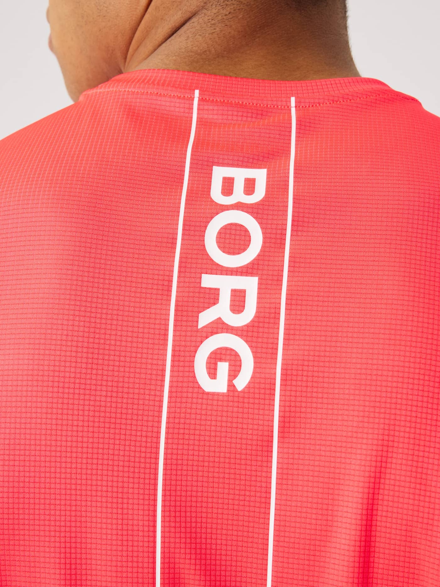 Detailed back view of the Ace Light T-Shirt in Diva Pink (Pink) showing the white Borg logo on breathable tennis mesh. - Image 4