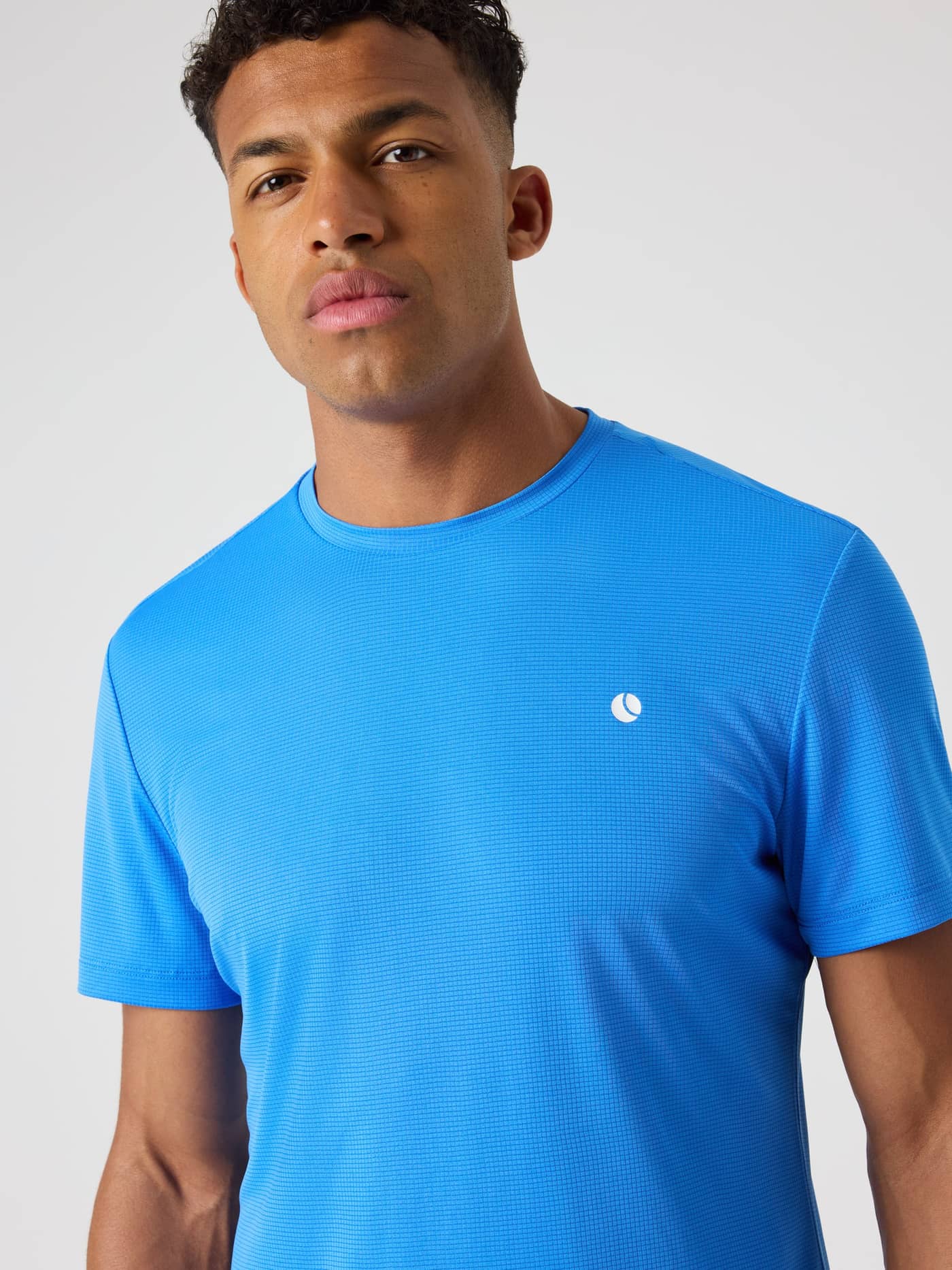 Front view of a man in the Björn Borg Ace Light T-Shirt in Palace Blue (Blue), a breathable performance top for tennis. - Image 4