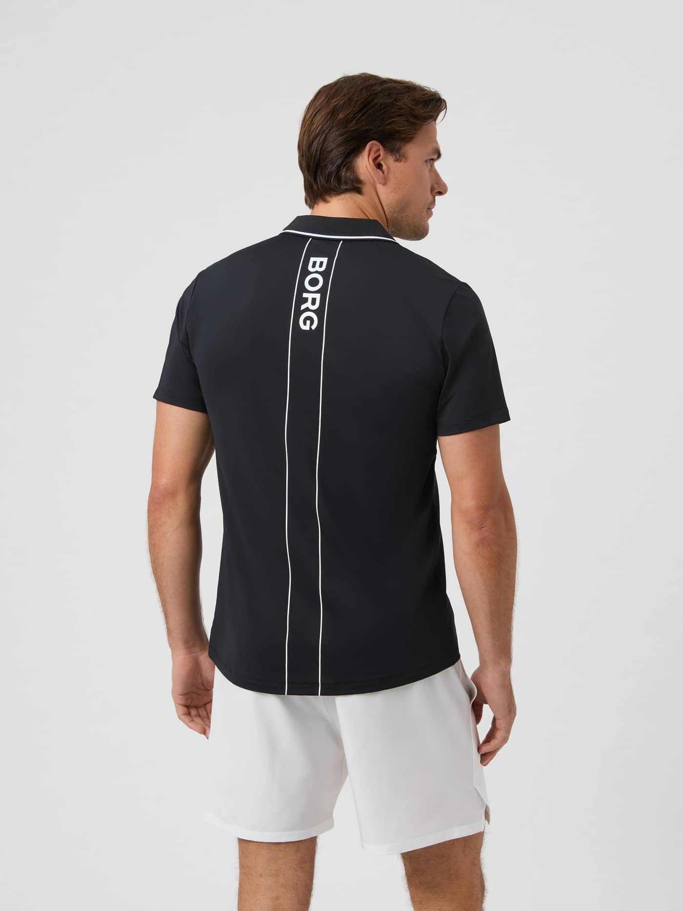Back view of the black Björn Borg Ace Polo Shirt on a model, showing the vertical BORG logo. - Image 2