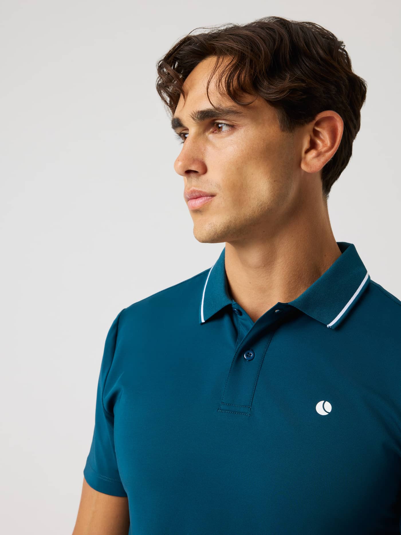 Front view of the Ace Polo Shirt in Reflecting Pond (Green) for tennis, with a white tennis ball logo and striped collar. - Image 5