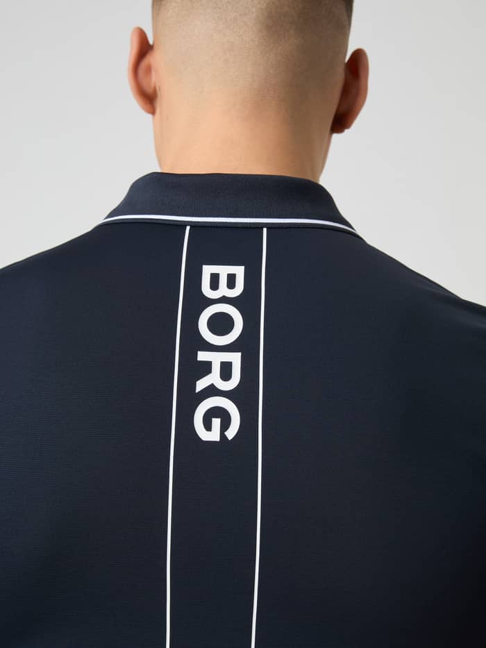 Close-up on the back of a model wearing the navy Björn Borg Ace Polo Shirt, highlighting the vertical BORG logo.