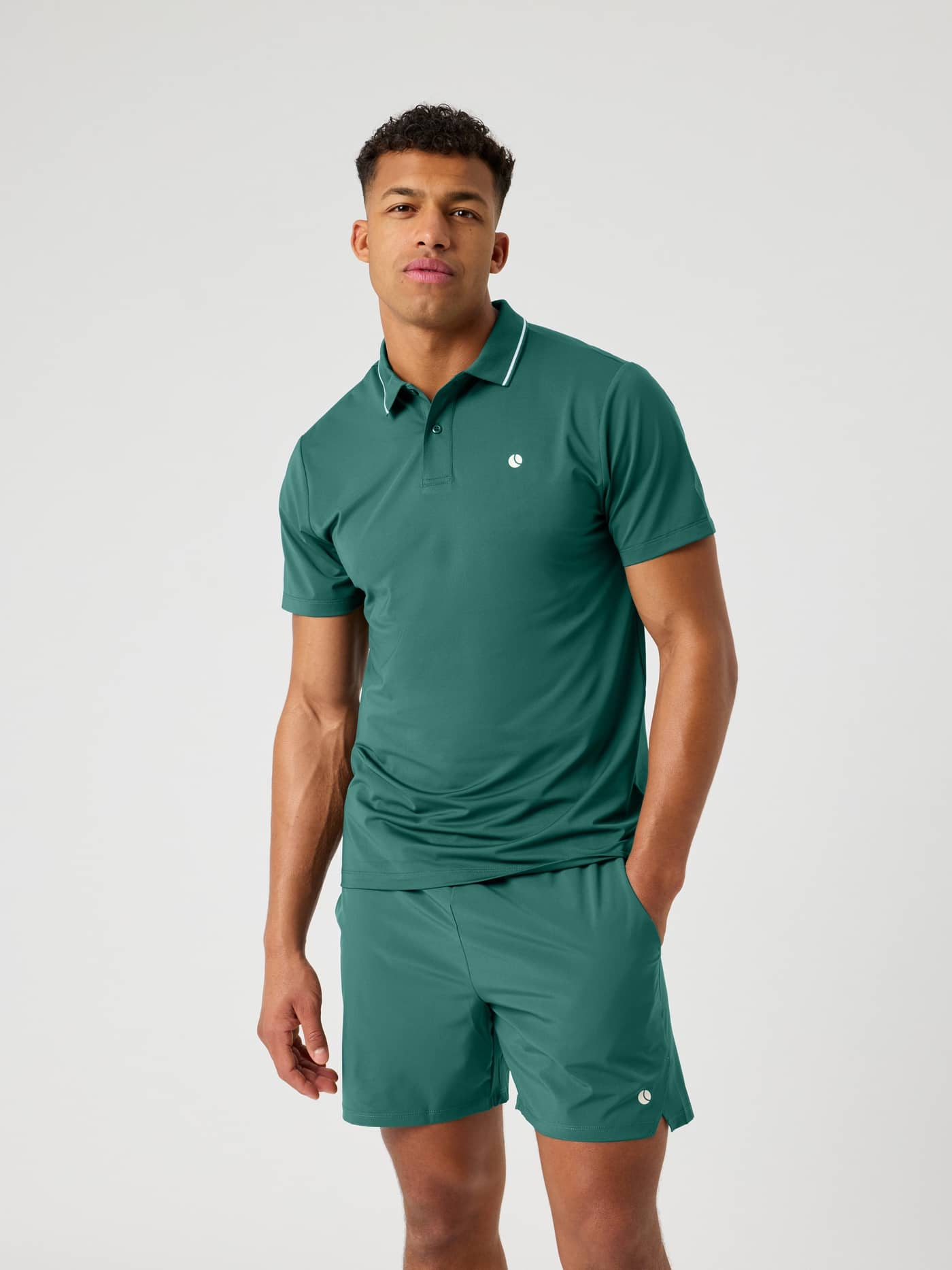 Vorderansicht eines Modells im Ace Polo Shirt in Mallard Green (Grün) mit weißem Logo und Kragenstreifen für Tennis. - Image 2