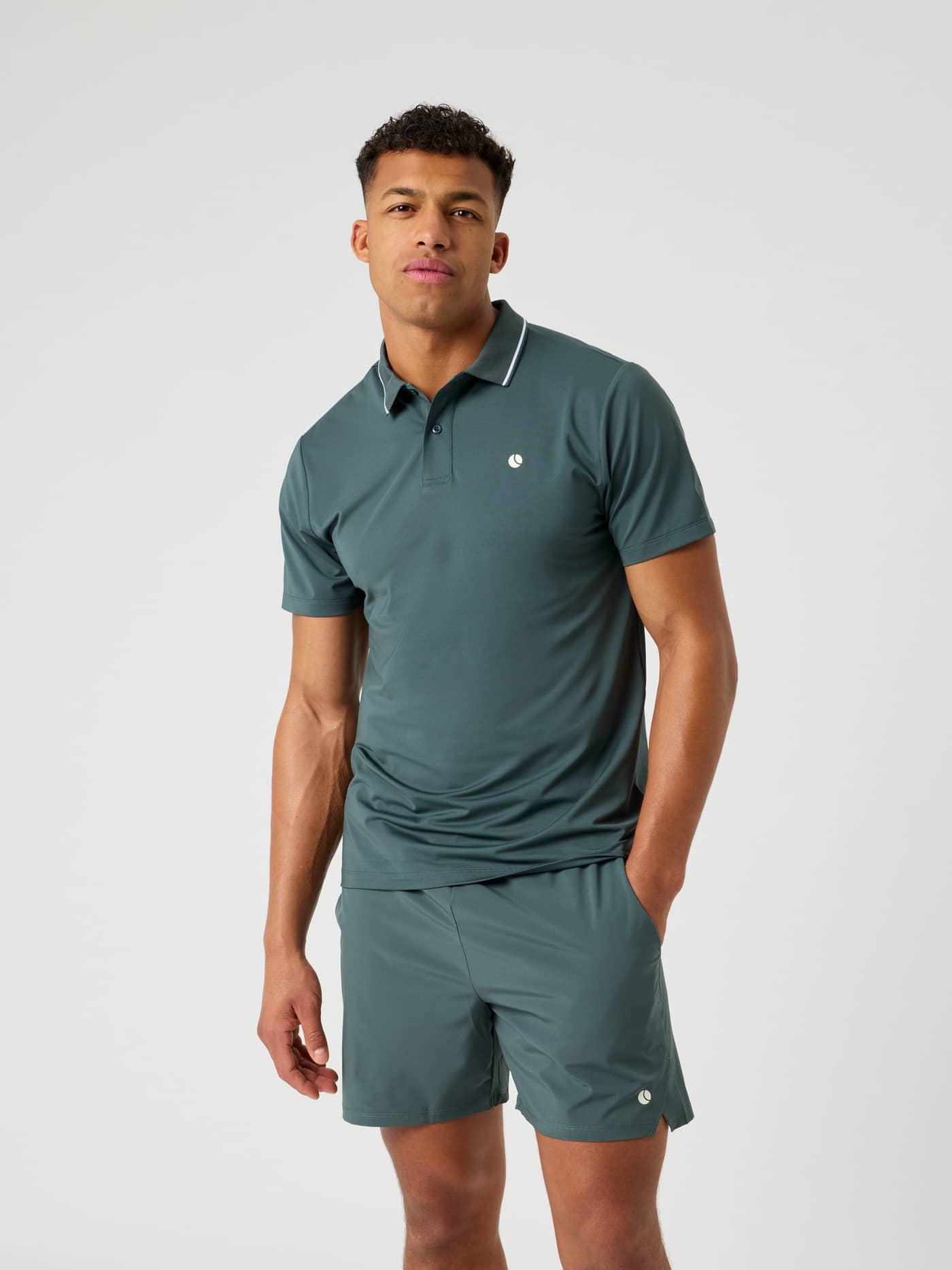 Front view of a man wearing the performance Björn Borg Ace Polo Shirt in Urban Chic (Green) for tennis. - Image 1