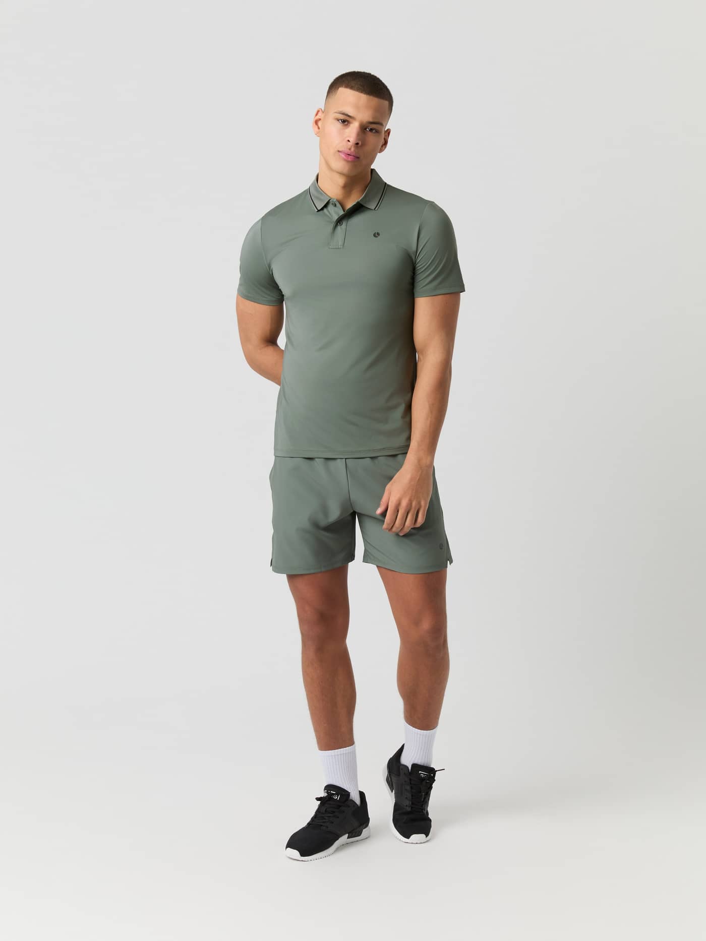 Front view of a model wearing the Björn Borg Ace Polo Shirt in Agave Green and matching shorts. - Image 3