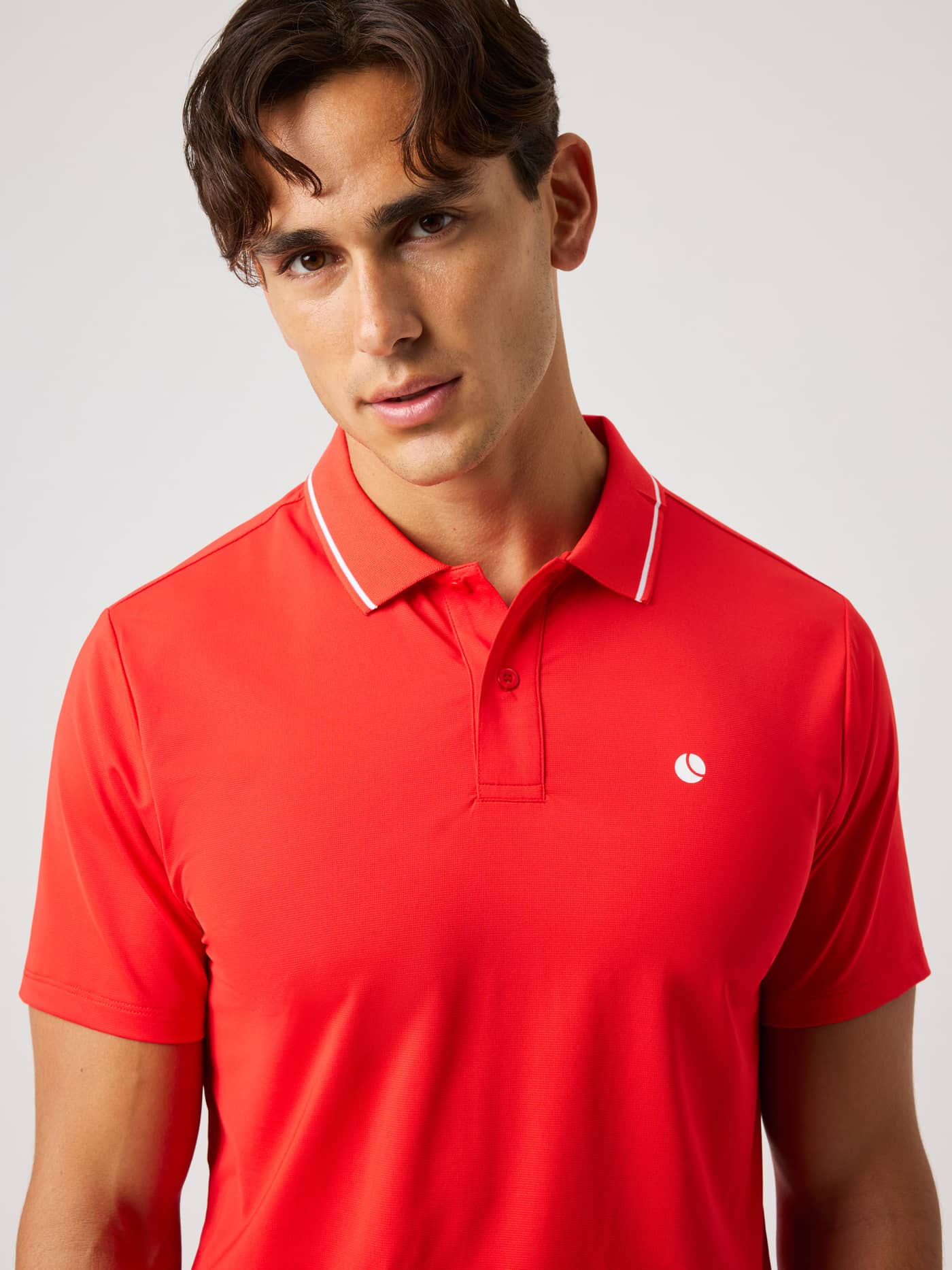Ace Polo Shirt in Flame Scarlet (Red) for tennis, featuring a contrast-striped collar and white tennis ball logo. - Image 6