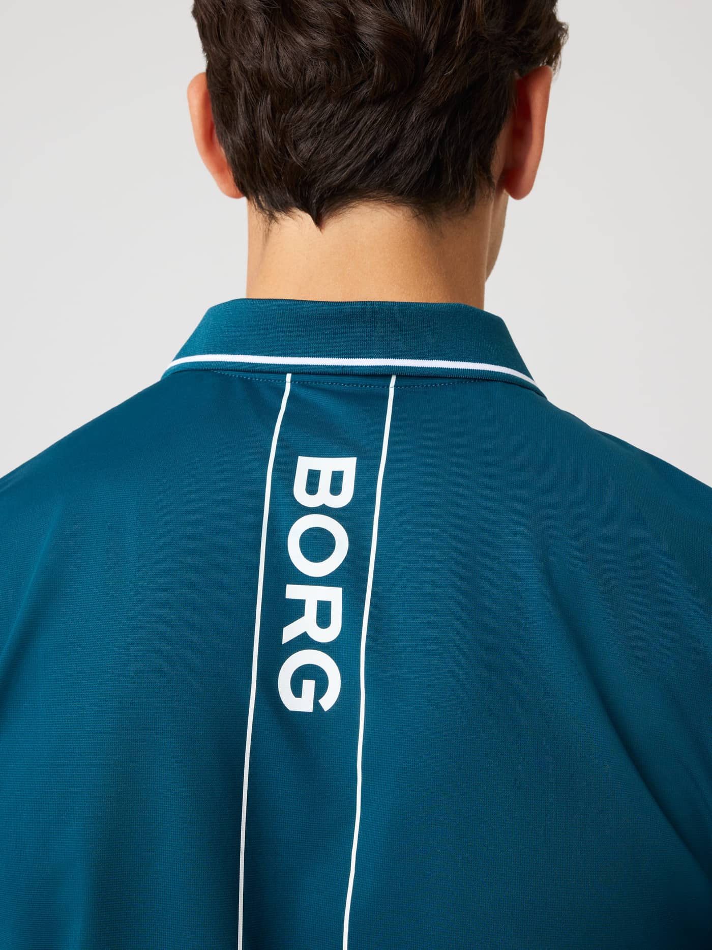 Ace Polo Shirt in Reflecting Pond (Green) featuring a white logo stripe on the back for tennis performance. - Image 4