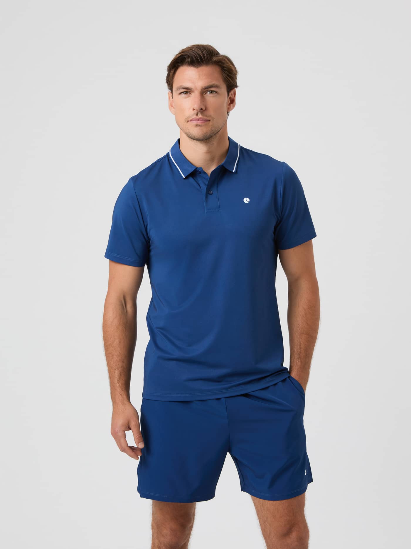 Front view of a model wearing the Estate Blue Björn Borg Ace Polo Shirt and matching shorts. - Image 1