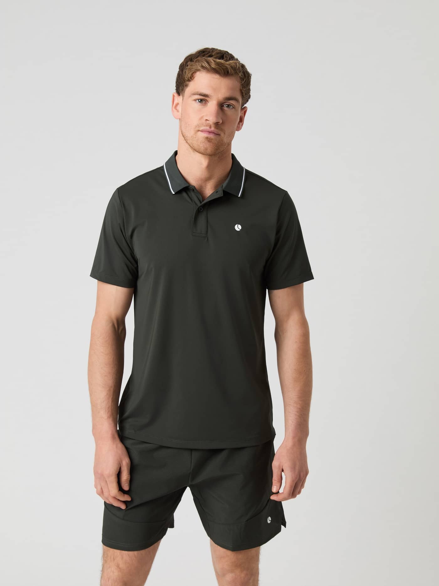 Male model wearing the Björn Borg Ace Polo Shirt in Peat, seen from the front. - Image 1